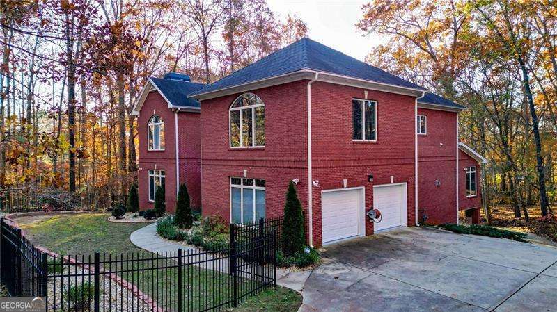 Need a home for a large multi family? This is it. Beautiful 4-sided brick home on a 4.54-acre oasis. This beauty boasts a newly renovated kitchen with a granite slab island, double ovens, 46-inch 6 gas burner w/ down draft vent, a trash compactor, and an oversized pantry. The Kitchen overlooks the large great room with built-in bookshelves and a fireplace. Step out of the great room into a 4 seasonal sun room overlooking the private backyard and a large deck with trex decking. The separate Dining room is grand with beautiful windows, a fireplace, and seats a table of 10 easily. A cozy computer/office room on the main floor is perfect for a home office. 4 bedrooms upstairs, an owner suite with fireplace and a newly remodeled spa bathroom, double vanities, a soaking tub, and a luxury shower & custom walk-in closet. The small upstairs loft area is a great place for a desk. The upstairs Secondary bedrooms are spacious, 1 additional full bath and a Jack & Jill bath makes a great addition for kids. A private stairway equipped with a chair lift to the enormous bonus room. The laundry room is grand with tons of storage. The home has a fully finished basement with a bedroom, bathroom, kitchenette, media room, and a huge patio with a drive-around boat garage. The front fenced yard has been beautifully and professionally landscaped. HVAC units are new, garage door & door openers recently replaced, ceiling fans replaced, garage floors treated and sealed, and septic cleared. No stops were taken when building this home and it features double pane, tinted Anderson windows, trex decking, a tankless water heater, an entire steel frame constructed onsite, and a stone-covered steel roof that is fire/180 mph windproof with a 50-year warranty. This one is a must-see.