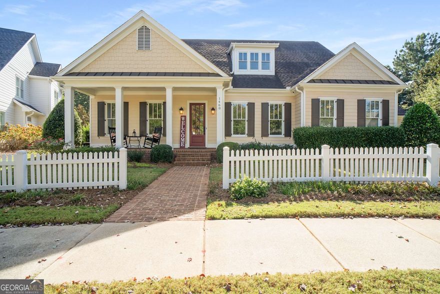 On a beautifully private lot in The Georgia Club, this stunning Rossmore plan captures the perfect blend of warmth, elegance, and timeless sophistication. From the moment you arrive, the home's charming curb appeal draws you in - with its brick-topped rocking chair front porch, white picket fence, and pristine landscaping. Step inside and you'll immediately notice the gleaming hardwood floors, impeccable millwork, and the care that makes this home look barely lived in. The dedicated dining room is ideal for hosting family holidays or intimate dinners with friends, while natural light pours through the main level, highlighting every detail. The inviting family room features custom built-ins framing a cozy fireplace, creating the perfect gathering space. The open-concept floor plan flows seamlessly into the chef's kitchen - a true centerpiece of the home. Enjoy granite countertops, double wall ovens, a spacious island, classic cabinetry, a butler's pantry, and elegant pendant lighting. The main-level primary suite is a peaceful retreat, filled with warmth and light from its many windows. The spa-like bathroom features a large tiled shower, dual sinks, and an expansive walk-in closet with custom wood shelving - a detail carried throughout every closet in the home. A guest suite with a tiled shower, a powder bath, and a well-appointed laundry room complete the main floor. Upstairs, you'll find two additional bedrooms, two full bathrooms, a versatile flex room perfect for an office, playroom, or library, plus a spacious loft area. The 4-car epoxied garage offers incredible functionality and storage, including a staircase leading to even more storage space - perfect for hobbies, workshops, or seasonal items. Step outside to the beautiful covered outdoor living area overlooking the peaceful, private backyard - the ideal spot to relax and unwind. Located in sought-after Oconee County within The Georgia Club, this home embodies the perfect blend of grace, comfort, and "home sweet home." Don't miss this rare opportunity - homes like this don't come along often! (Quarterly Lawn Maintenance fee of $586.00)