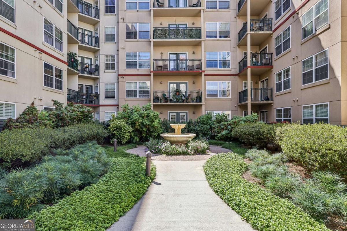 Discover the ultimate in convenience and style with this exceptional 1-bedroom condo, perfectly positioned for an effortless urban lifestyle. Step out your door and you're just a short walk from the vibrant Downtown Decatur square, where an endless selection of bars, restaurants, and shops await. Commuting is a breeze with the Marta train just a stone's throw away. This bright and airy unit is flooded with natural light from expansive windows. The private patio overlooks the pool, creating a serene escape. Inside, you'll find a spacious primary bedroom with a large walk-in closet and a bonus flex space-ideal for a dedicated home office, a cozy reading nook, or a creative studio. Plus, the convenience of an in-unit washer and dryer means laundry day is hassle-free. The building itself is an extension of your living space, offering incredible amenities. Unwind by the pool with a grilling area, stay active in the gym, find your zen in the yoga room, or relax with a movie in the media room. Your rent simplifies your life, including a reserved parking space in the garage, water, internet, and cable.