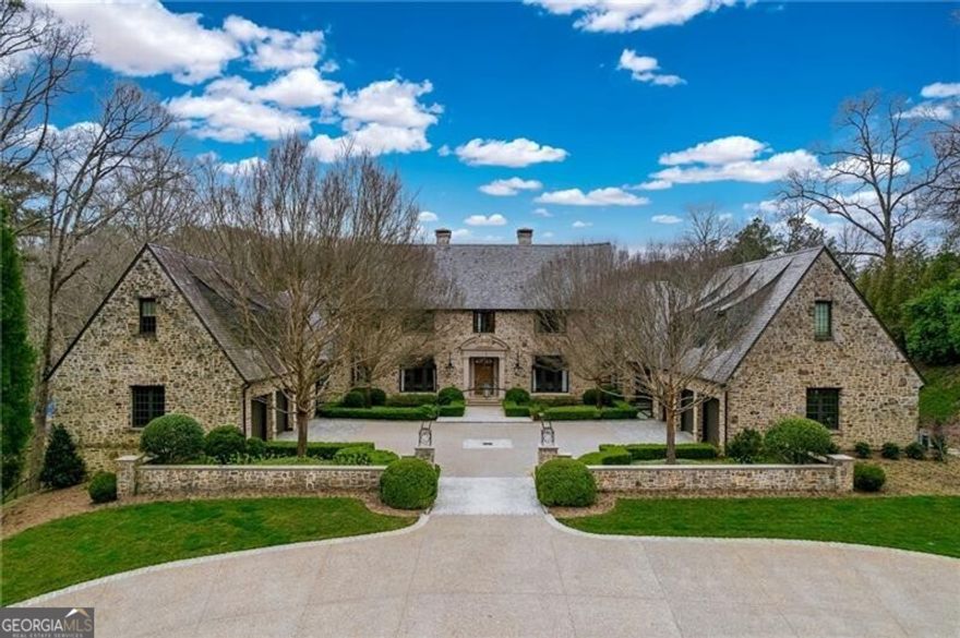 This stunning Stan Benecki home on 2.6+/- acres has been thoughtfully renovated by the current owners and truly has it all - oversized living spaces ideal for entertaining, a beautiful light-filled kitchen with oversized island, La Cornue range, marble counters and newly added scullery, plus a spacious primary suite on main with renovated primary bath and renovated closets. The main level has beautiful arched iron windows and doors along the back of the house, offering a lot of natural light and views of the lovely backyard. The large newly renovated kitchen opens to the great room with fireplace. The upper level has 4 bedrooms all with en-suite baths, as well as laundry and bonus room. The current owners finished the attic spaces over each wing of the garages, which adds an additional bedroom, bathroom and sitting room on each side and is complete with their own separate staircase, ideal for guests or au-pair suite. Truly breathtaking outdoor spaces feature a total pool renovation, an added pool house with kitchen, bedroom and bath complete with accordion doors in the living room. No detail has been left untouched in the pool house, the style is light and airy with a resort feel, its breathtaking. The backyard has been transformed with a new pickle ball court, artificial turf and screened-in porch. Luxurious basement amenities include a theatre room, 2 recreation rooms with a newly added built-in bar, sauna, gym and temperature-controlled wine cellar. Updated both inside and out, this gated home also offers a newly added circular driveway, 6-car garage and parking pad. Additional list of features includes: whole house generator, whole house double charcoal water filtration system, HVAC for wine cellar, refinished floors throughout, added basement hardwood floors and new gas pool heater. The current owners have truly maximize both the outdoor and indoor spaces in this Buckhead home, it's truly a must see!