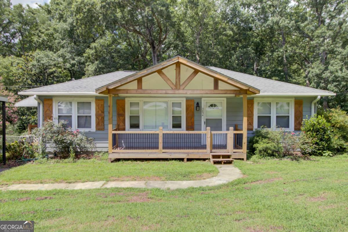 MOVE-IN READY FIXER-UPPER SPECIAL IN SOUGHT-AFTER SUWANEE! Discover an exceptional opportunity in the heart of Suwanee, Georgia, with this 3-bedroom, 1-bath property. Perfect for those looking to add their personal touch and build equity, this home combines a fantastic location with a solid foundation. Enjoy natural hardwood throughout the house and upgraded cabinets in the kitchen. Ceiling fans are installed in every room for comfort. The kitchen comes equipped with a stove and microwave, and conveniently connects to a combined dining area. Please note, there is no dishwasher or refrigerator. The outdoor space features a lovely deck that extends off the back porch, offering a perfect spot for relaxation, overlooking a large, fenced-in backyard that backs up to a serene creek. The property also boasts an unfinished basement, providing ample space for future expansion or customization. Utilities include a natural gas water heater and a fully functional, hard-wired generator, ensuring peace of mind during any power outages. You'll enjoy the easy access to local parks and attractions such as Suwanee Town Center, Suwanee Creek Greenway, and Sims Lake Park. Priced to sell. Be the first to see it.