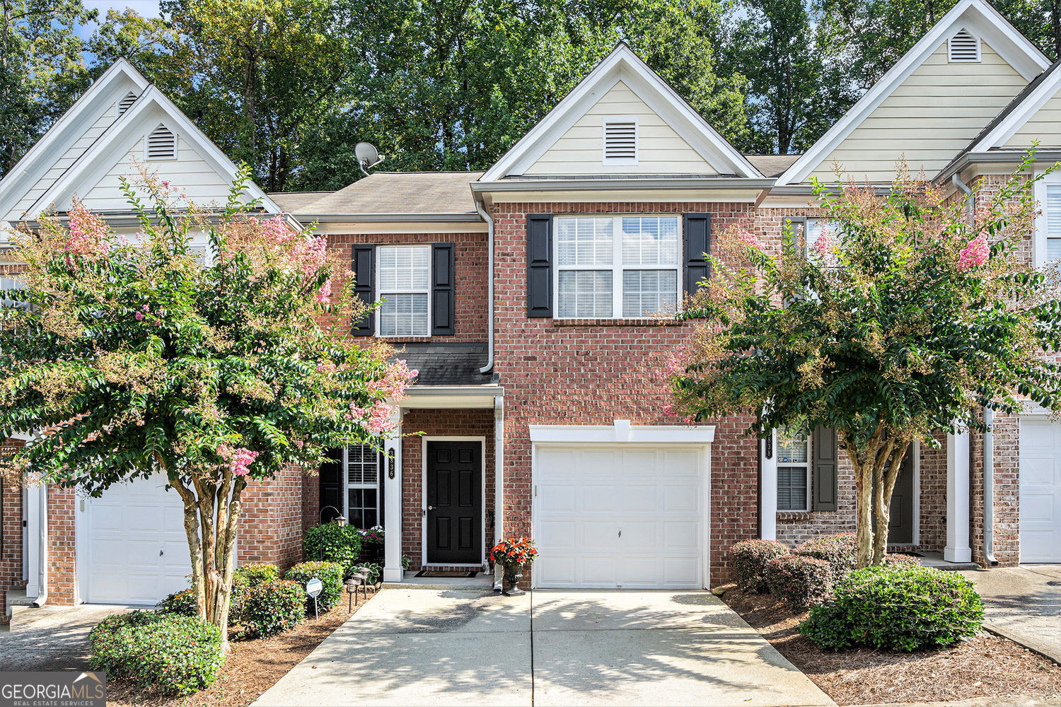 Beautiful immaculately maintained 2 bed, 2.5 bath home with NEW HVAC and NEW Water heater in sought after Laurel Oaks community with an open floor plan. Beautiful hardwood floors throughout the main level and carpet in stairs and bedrooms of upper level. Family room has soaring vaulted ceiling, contemporary floor-to-ceiling fireplace and views from the kitchen and dining area. Kitchen features gorgeous granite countertops, a beautiful backsplash and fabulous stainless steel appliances. Updated fixtures throughout the home like new light fixtures, new paint in bedroom, living room and kitchen, new hvac system, new water heater. Master bath features granite countertops, a soaking tub with stainless steel fixtures, separate shower and a large walk-in closet. Laundry conveniently located upstairs in the hallway. Secondary bedroom is spacious with its own bathroom that features granite countertops and tub/shower and walk-in closet. Community features 24 hour surveillance, sidewalks, and plenty of guest parking. Living in this great community will give you easy access to interstate I-85, Pleasant Hill Road, walkability to grocery stores, Corley elementary school, restaurants, and entertainment. Low HOA dues covers exterior, landscaping, termite, and pest control. Hurry! This one won't last.