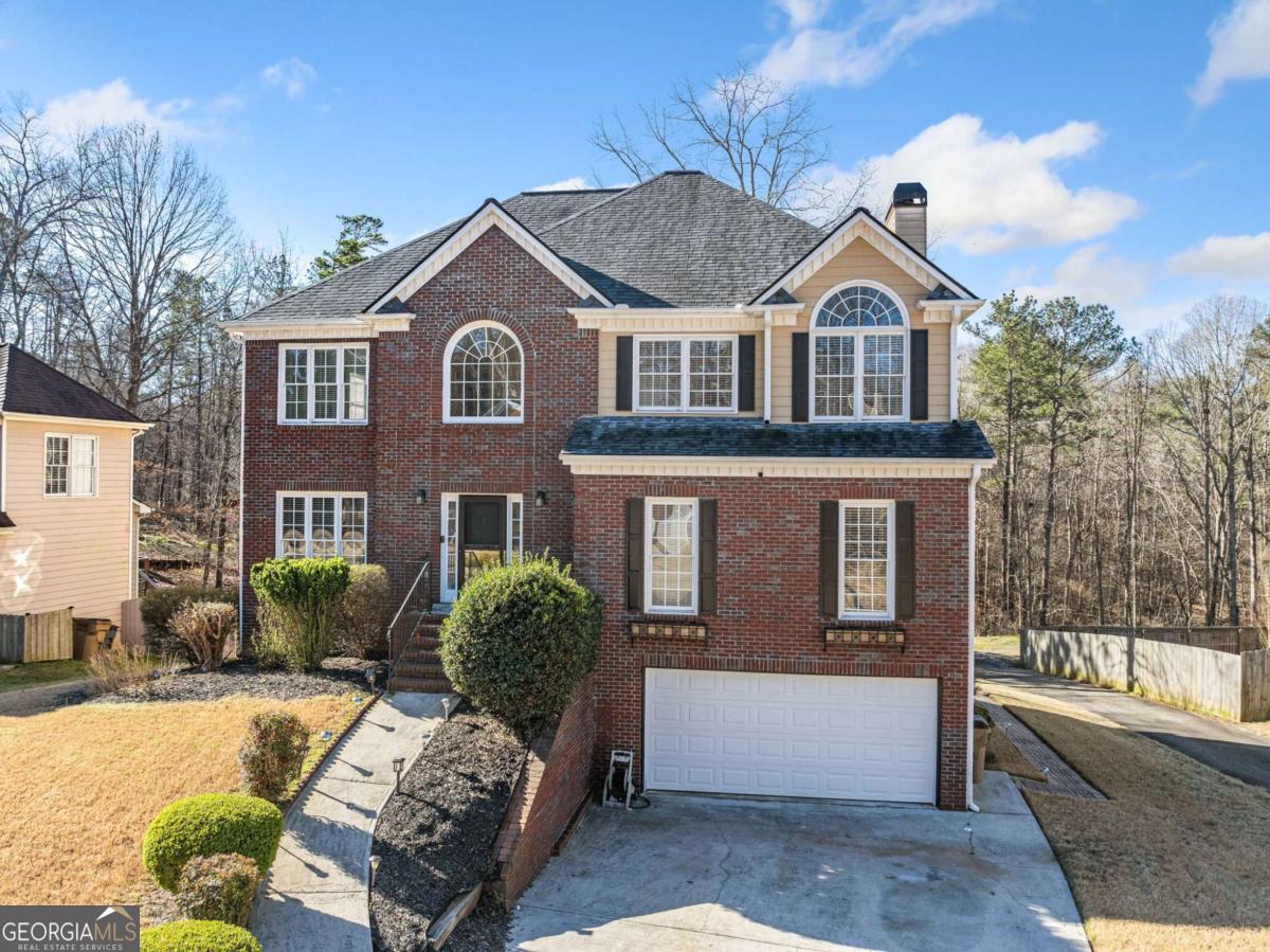 This stunning 7-bedroom, 4.5-bathroom brick-front home is located in the highly desirable Etowah High School District near the cul de sac. It features a main-level master bedroom and bathroom, along with an additional master suite upstairs, making it perfect for families or guests. The spacious eat-in kitchen seamlessly connects to the main living room, creating an ideal space for entertaining. Step outside to enjoy a large grilling deck that overlooks a level backyard, perfect for gatherings or outdoor activities. Upstairs, you'll find four additional bedrooms and an updated bathroom, providing ample space for everyone. The basement is a fantastic feature, boasting a full kitchen and bathroom, making it an excellent hang-out space or potential in-law suite. This home is conveniently situated near marinas on Lake Allatoona and Hobgood Park, with easy access to the Outlet Shoppes of Atlanta and the vibrant shopping and dining options in Downtown Woodstock. It truly offers a perfect blend of comfort, style, and location!