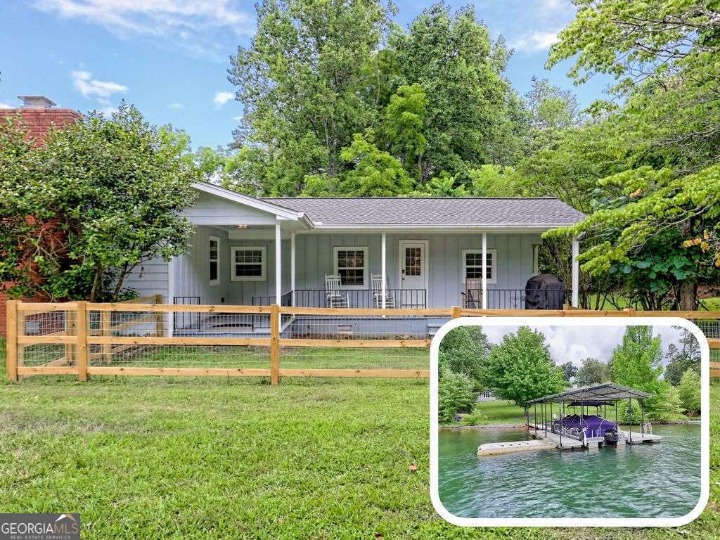 Charming Lake Chatuge Cottage featuring 2 bedrooms and 2 baths, along with a single slip covered dock that includes a swim deck and jet ski float. The property is being offered furnished. The main living area boasts expansive windows to capture water views year-round, complemented by classic architectural arched openings and a tongue-and-groove ceiling. The interior includes a kitchen with bar seating, dining room, sunroom/lounge space, a large family room, spacious primary bedroom with full bath, and a bunk room with an additional full bath. Enjoy leisurely time off the lake on the screened porch, which overlooks the backyard and dock area. The property has a gentle slope to the water with 0.585 unrestricted acres above the 1933 line and 0.111 acres below it for a total of 0.696 acres, over 100 feet of shoreline and year-round water. Nestled in the Ledford's Chapel area of Lake Chatuge with a wide cove, it offers plenty of space for swimming and kayaking without being on the main channel. Improvements since 2020 include a new roof, new siding and exterior paint, encapsulated crawlspace with dehumidifier, screened porch, new well pump and filter, fenced area, new flooring and HVAC. Improved parking can accommodate family and friends, making this a smart choice for anyone seeking a lakefront getaway.