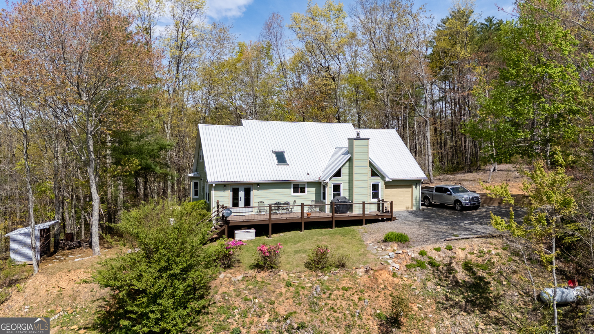 Welcome to this charming 6-bedroom, 2.5-bathroom home, perfectly nestled on 3.55 acres of beautiful, peaceful land. Located in a quiet neighborhood with no HOA, this property offers the ideal blend of privacy, comfort, and modern upgrades. Whether you're enjoying the serene mountain views or relaxing indoors, you'll feel right at home. The spacious layout includes six generously sized bedrooms, with a master suite conveniently located on the main level. The master bath features a newly renovated shower, creating a spa-like experience for your daily retreat. With a brand new metal roof and siding, this home is not only modern in style but built to last. For added convenience, the whole home is equipped with a Generac generator, ensuring you'll have power during any outage. The cozy living areas are perfect for relaxing or entertaining, with a wood-burning fireplace adding warmth and charm to the space. Above the kitchen, you'll find a unique loft area, offering additional room that could be used as a home office, a reading nook, or a fun hangout space. One of the most standout features of this property is the amazing year-round mountain views. Whether you're sipping coffee on the deck or enjoying the view from inside, the natural beauty of the surrounding mountains will never get old. With no HOA restrictions and plenty of room to spread out, this home provides the perfect peaceful retreat. If you've been looking for a home that offers privacy, stunning views, and modern features, this is the property for you!