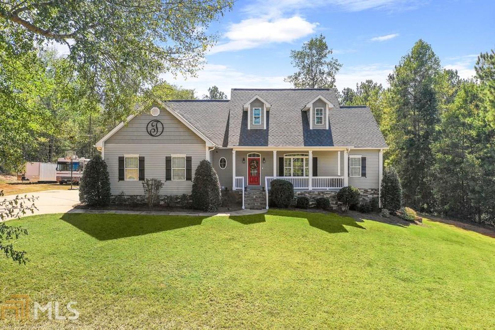 Convenient Pike County home in Highgrove Subdivision, a one street cul-de-sac community! Full basement w/private in-law or guest suite and a 30 x 30 detached shop on 2.27 acres! What more could you want for the money? Total of 4 bedrooms & 3 full baths (3 bedrooms/2 baths on main plus in-law suite in basement for additional 4th bedroom & 3rd bath)! Open and airy family room has fireplace w/gas logs & blower and built in bookcases/desk, cheerful kitchen w/wood cabinetry, granite counters, stainless steel appliances, & dining area w/access to the deck for entertaining. Split bedroom plan, private owner's suite has beautiful double trey ceiling w/molding details, tile bath w/jetted soaking tub, sep shower, dual sink vanity, and big walk-in closet. Tile laundry room w/cabinets & utility sink, real hardwood floors in all main living areas. The basement has a private guest suite with a kitchenette room, laminate hardwood flooring, and a bedroom and full bath w/private outside entry! There are endless possibilities for future expansion in the basement too (think rec room, theater room, home gym, etc). Rocking chair front porch, multi level rear deck (partially covered), above ground pool, 30 x 30 detached double bay shop w/gravel drive, 220 electric service, & plumbed with air drops for air compressor and plentiful electrical outlet supplies, sprinkler system, power hookup for RV, great lawn space, 2 car side entry attached garage, garage door/shop area in basement, well has hard water/salt filtration system, camera surveillance system & alarm system w/glass break sensors, 2 year old architectural roof, and brand new water heater, all on a 2.27 acre lot at end of the street. One of the most convenient locations in Pike near 19/41, Hwy 19, Zebulon, Griffin, shopping, dining, schools, gym, etc.