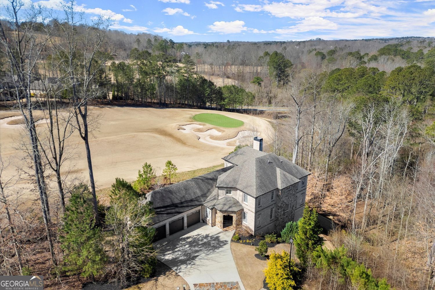 Set on a 1-acre lot amidst lush conservation areas, this custom-designed 5-bedroom, 4.5-bath home boasts stunning views and exceptional craftsmanship. The impressive 4 side brick and stone exterior is highlighted by custom double wood French doors. Soaring 12-foot ceilings, hardwood floors, freshly painted walls, and upgraded light fixtures throughout. The gourmet kitchen is a chef's dream, equipped with a large island, premium JennAir appliances, a farmhouse sink, soft close drawers and doors and a custom walk-in pantry. The main-level master suite provides a private sanctuary with double vanities, a spa-like shower, and a custom closet. Upstairs, three additional bedrooms, including a second master suite with a soaking tub, walk-in closet, and dual vanities. The expansive two-story basement with 18- and 23-foot ceilings is filled with natural light and features energy-efficient spray foam insulation, providing endless opportunities for customization. A three-car garage adds to the home's exceptional features. The beautifully landscaped two-level backyard offers a private escape, with the lower section recently cleared of trees for an open, inviting space. The backyard also features a newer retention wall and irrigation system. Echelon, a gated luxury golf community in Alpharetta, GA-known as "Atlanta's High Country Estates"-offers expansive homes on large lots, a premier golf course, a clubhouse, and breathtaking views of rolling hills and serene lakes. Residents enjoy top-rated schools, fine dining, and shopping, all while being just a short drive from the vibrant heart of Alpharetta and Milton.
