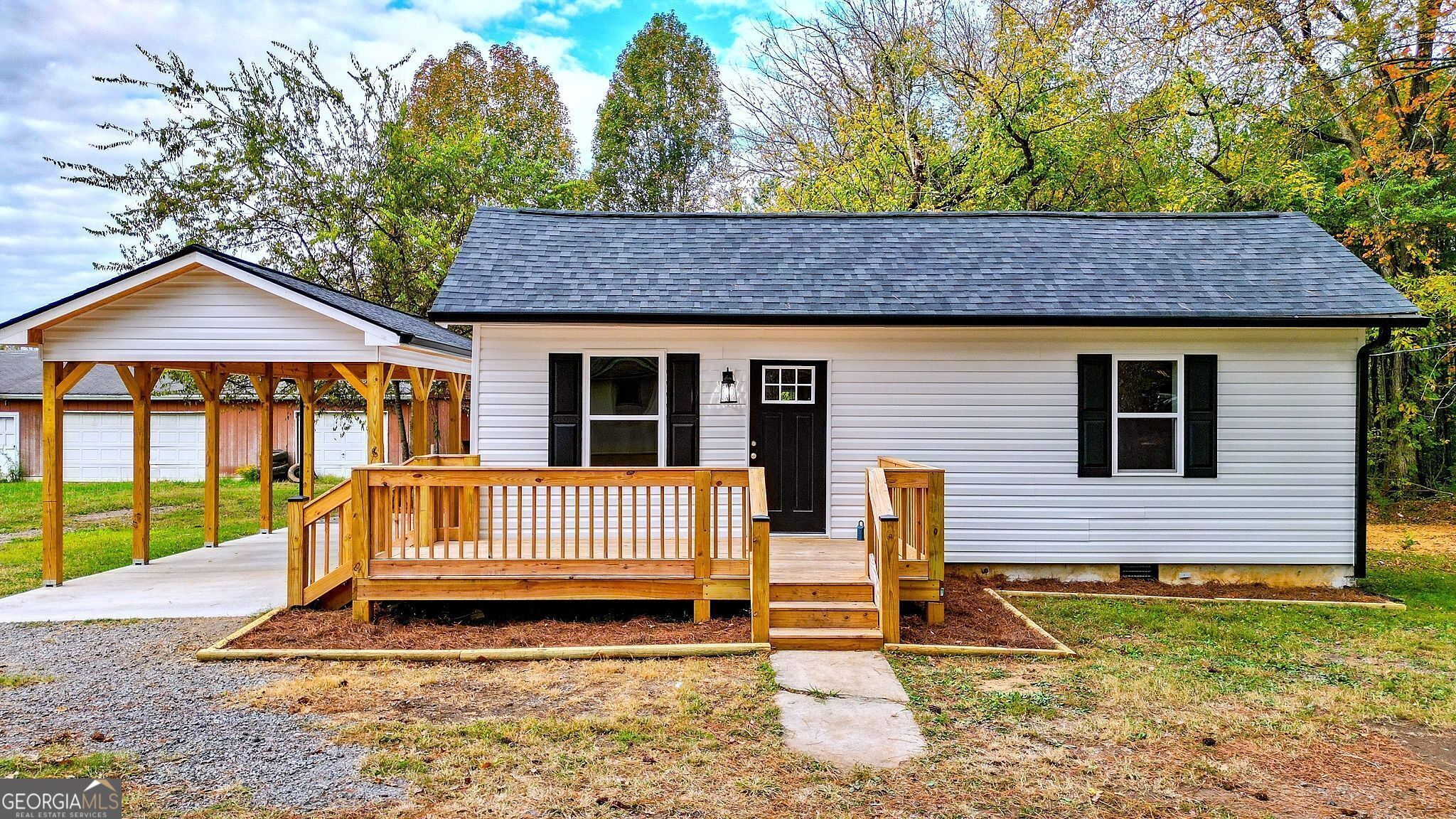 Introducing a charming bungalow that has been meticulously renovated. This delightful one-story home combines modern elegance with timeless appeal, making it the perfect space for comfortable living. This property offers both style and convenience. A quaint front porch provides an inviting entryway, perfect for enjoying your morning coffee or greeting guests. Step inside, and you'll be greeted by brand new hardwood floors that lead to the brand new kitchen. The renovated kitchen is a chef's dream, with sleek, modern appliances, granite countertops, and ample cabinet space. This bungalow offers two cozy bedrooms with abundant natural light, fresh paint, and new flooring. The master bedroom includes a spacious closet, ensuring you have plenty of storage for your wardrobe and personal items. The second bedroom is perfect for guests, a home office, or a child's room. The bathroom has been completely updated with modern fixtures, a stylish vanity, and a shower/tub combination. Additional features include a back deck which offers a lovely outdoor space for barbecues and relaxation. The property includes a one-car carport and an outbuilding for spacious storage. This beautiful turnkey home blends modern convenience with classic charm. It's a space where you can create lasting memories and enjoy the comforts of contemporary living. Don't miss the opportunity to make this meticulously updated property your new home. Contact us today to schedule a viewing and see the transformation for yourself. The shop is NOT part of the property.