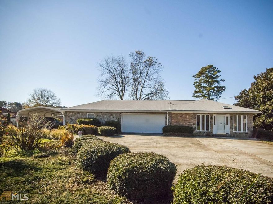 Prime Location,huge corner lot loaded with lots of trees,shrubs and plants.Well maintained stepless brick ranch.3 bedroom 2 full baths,total electric,Huge family room,living room,separate dining room,Beautiful sun room with lots of windows leading out to gorgeous level lot with fenced backyard,laundry room off kitchen, 2 car garage and separate workshop. Attached awning for extra covered parking.Move right in and add your decorating and updates for a perfect home. Minutes from I20,restaurants,schools,shopping and hospital. Hurry this one won't last long !