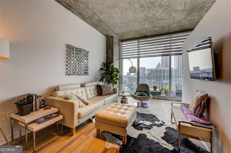 Are you ready to live the Midtown lifestyle? You may have just found your next home! South facing, with sunrise and sunset views, this sunny & light filled condo is ready for you! Upon entry, you'll be awestruck by the view of downtown from the floor to ceiling windows. Your next home has been fully updated with new engineered hardwood floors, custom stainless steel tile in the kitchen, S/S appliances, beautiful bathroom tile with walk in shower and a floating vanity. You have custom closets to maximize storage, custom blinds, 10 ft ceilings, upgraded lighting and a deeded parking space. Your HOA includes resort style amenities such as a swimming pool, fitness center, 24 hour concierge, high speed internet and so much more! Take advantage of Midtown's walkability: shopping, restaurants, Piedmont Park, Marta and more are all just steps away! What sets this condo apart from others, is the upgrading and remodeling are already done! All it needs is you and your special touches. Set up your easy viewing today!