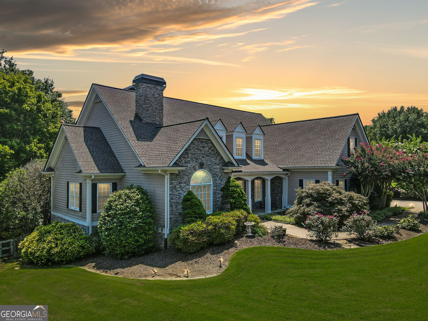 Overlooking manicured fairways and a sparkling lake, this home in Bradshaw Farm offers serene golf course living with space to stretch out and breathe. From the moment you arrive, the curb appeal is undeniable. Mature landscaping, wide driveway, and a stately front elevation set the tone for what's inside. The main floor features a bright and open great room anchored by a stacked-stone fireplace and vaulted ceilings. Just off the breakfast area, a sunny enclosed porch invites you to slow down and stay awhile, while the expansive back deck gives you front-row seats to the golf course. The three car garage offers additional parking for that golf cart. The updated kitchen is both stylish and functional, with granite countertops, stainless steel appliances, and a large center island for prepping or gathering. The primary suite on the main level offers a private retreat with a second fireplace, walk-in custom closet, and soaking tub with views of the trees. The upper level features three spacious bedrooms, each with its own ensuite bathroom. One of the bedrooms includes a private sitting area that can serve as an additional living room or retreat, offering extra privacy. A versatile bonus room upstairs provides the perfect space for teens, guests, or a home office. The finished terrace level includes a full in-law suite with a second kitchen and laundry, offering space for extended guests, teens, or multigenerational living complete with its own fireplace and private entrance. A workshop and bonus rooms are ready to be customized for your needs: gym, media room, hobby space, or all three. And when it's time to step outside, Bradshaw Farm delivers with a full lineup of amenities: golf, clubhouse, tennis courts, pools, and playgrounds, all just a quick walk or cart ride away. This one checks every box and then some.