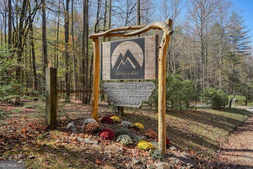 Escape to a place in North Georgia in the Blue Ridge Mountains that encapsulates the outdoor enthusiastCOs dream. Welcome to Mulberry Gap Adventure Basecamp. Never before offered for sale. Mulberry Gap is at 15.6 acre property located in Murray County, GA just outside the county line of Gilmer County and northwest of Downtown Ellijay, also bordering a national forest outside of the Cohutta Wilderness Management Area and the Chattahoochee National Forest. Ellijay, the Mountain Bike Capital of Georgia, is known nationally for some of the best trail systems in the South and even the nation. It boosts many species of trees from hardwoods, pines, and the coveted hemlock. There is a small koi pond with a natural creek that runs through the property and echoes the sound of nature. Mulberry Gap is a place where outdoor recreation enthusiasts have been visiting for over 17 years. The property hosts its own flow trail, jump line, and pump track for mountain bikers, and sits within direct access to trails right outside the gates, including the infamous Pinhoti Trail that runs from Alabama to South Carolina as one of the few national trail systems that allow mountain bikes. The amenities include over 11 cabins (room for more), two bathhouses, 8 campsites, 3 car camping sites with electricity, an office/check-in/retail space with staff quarters to stay overnight and a renovated barn that has been converted into a gathering space for family-style meals, late-night games, and satellite TV. The Barn is also where all the family-style meals are prepared in a commercial kitchen for breakfast & dinner on the weekends, or even a sack lunch by demand. There are two community hot tubs, nestled creekside in between the cabins great for a morning soak or a post-adventure recovery. Mulberry Gap offers shuttles throughout the week for the mountain biker or hiker looking for pick up or drop off. It also hosts many events from corporate retreats, trail races, bike events (demos), weddings, family gatherings, club retreats, and anything where people can gather. This is a turnkey property, that is fully operational. Along with the purchase of the property comes a business that has grown into a sustainable and growing future. All furniture, fixtures, appliances, equipment will convey along with shuttle vehicles.This property can never be duplicated it is grandfathered in to be what it is today. Don't miss this incredible opportunity! To learn more, email info@goadhomepartners as we have built a detailed due diligence packet for prospective buyers.