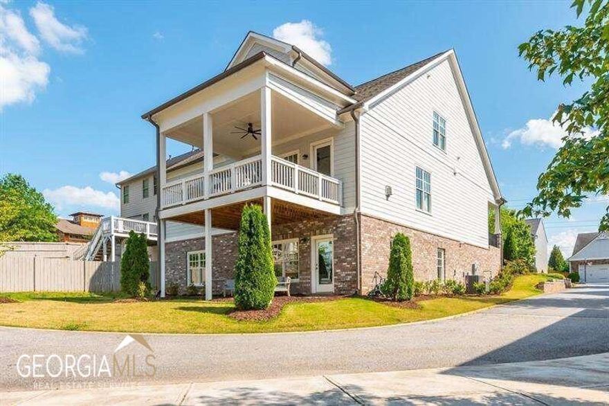 This stunning Brock Built home is a designer's dream! With its master bedroom on the main level, it offers the perfect blend of luxury and convenience. Situated in a highly desirable neighborhood, this exquisite home boasts upscale architectural details and thoughtful design elements throughout. Modern built-ins and hardware add a touch of sophistication and elegance. The main level's 10-foot ceilings and tall doors add to the beauty of this home. The kitchen is a chef's paradise, boasting a huge pantry that provides ample room for all your culinary essentials. The strategically placed laundry area opens to the hallway and owner's closet. Upstairs, there are two spacious bedrooms and a loft that fills with natural light. Immense amounts of storage on every floor, along with custom closets, provide practicality and ensure that your belongings are organized to perfection. The fully finished basement is open, and light floods in through its wrap-around windows. There is a versatile family entertainment area and a personal gym with professional-grade rolled rubber flooring for equipment. Additionally, there is a rejuvenating true steam shower in the basement. The additional bedroom in the basement makes for the perfect office or in-law suite. Walk directly from the basement onto the covered back patio and embrace the serenity of outdoor living. Whether you want to entertain guests or simply enjoy some quiet time, this space is perfect for making lasting memories. Steps away from neighborhood amenities and minutes away from Downtown Woodstock, this home is the perfect blend of functionality and style. Don't miss the opportunity to make this extraordinary home yours.