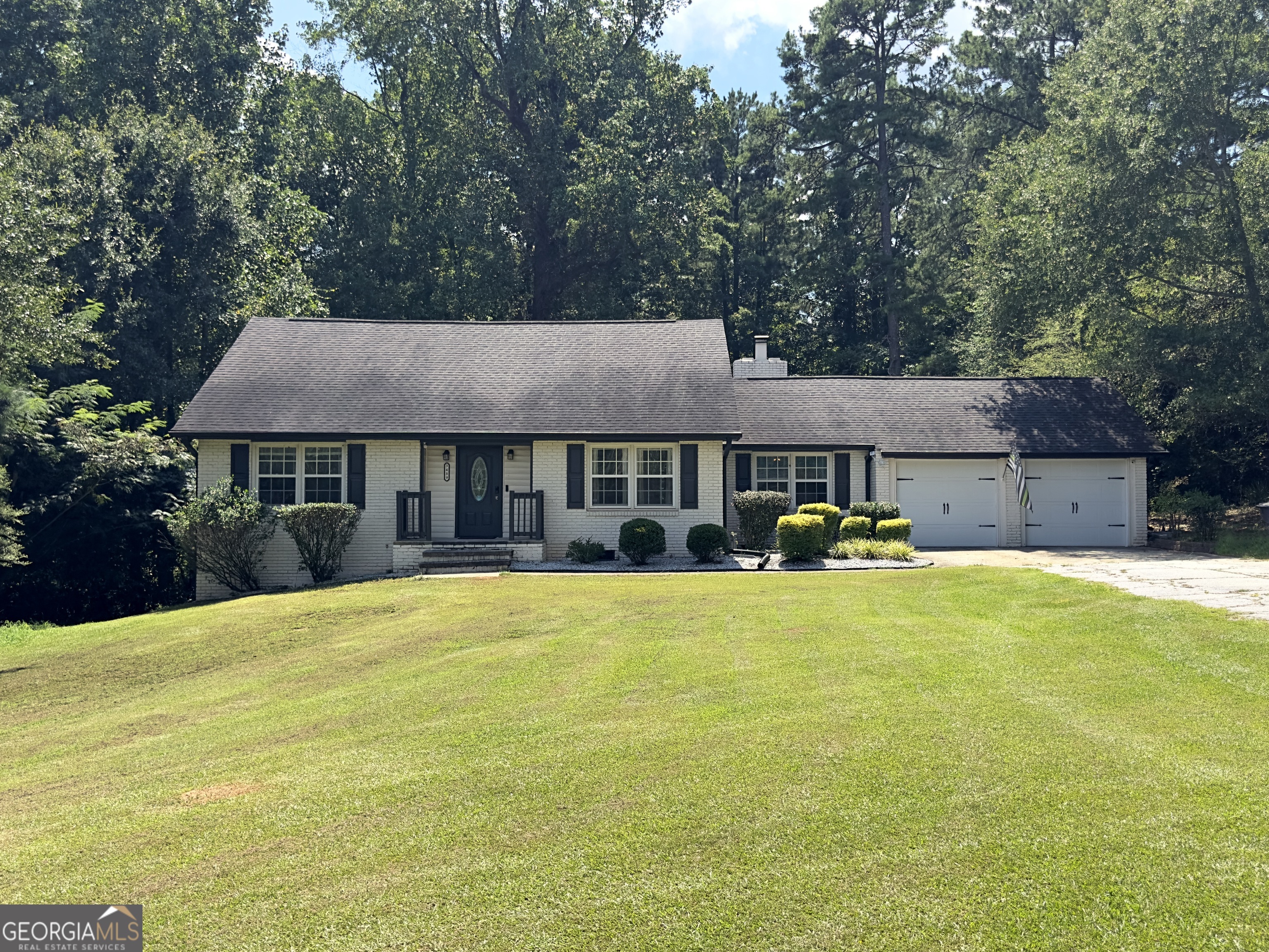 Welcome to this charming Covington home nestled on 1.81 acres of peaceful land. Originally built in 1966 and updated over the years, this property blends timeless character with modern comforts. Inside, you'll find 3 bedrooms and 2 bathrooms, beautiful hardwood and carpet flooring, and a cozy fireplace that makes the living space warm and inviting. The exterior is just as impressive, featuring a classic stone-and-wood facade, an attached garage. With a privacy-friendly setting and plenty of yard space, this property offers a wonderful balance of charm, comfort, and convenience.