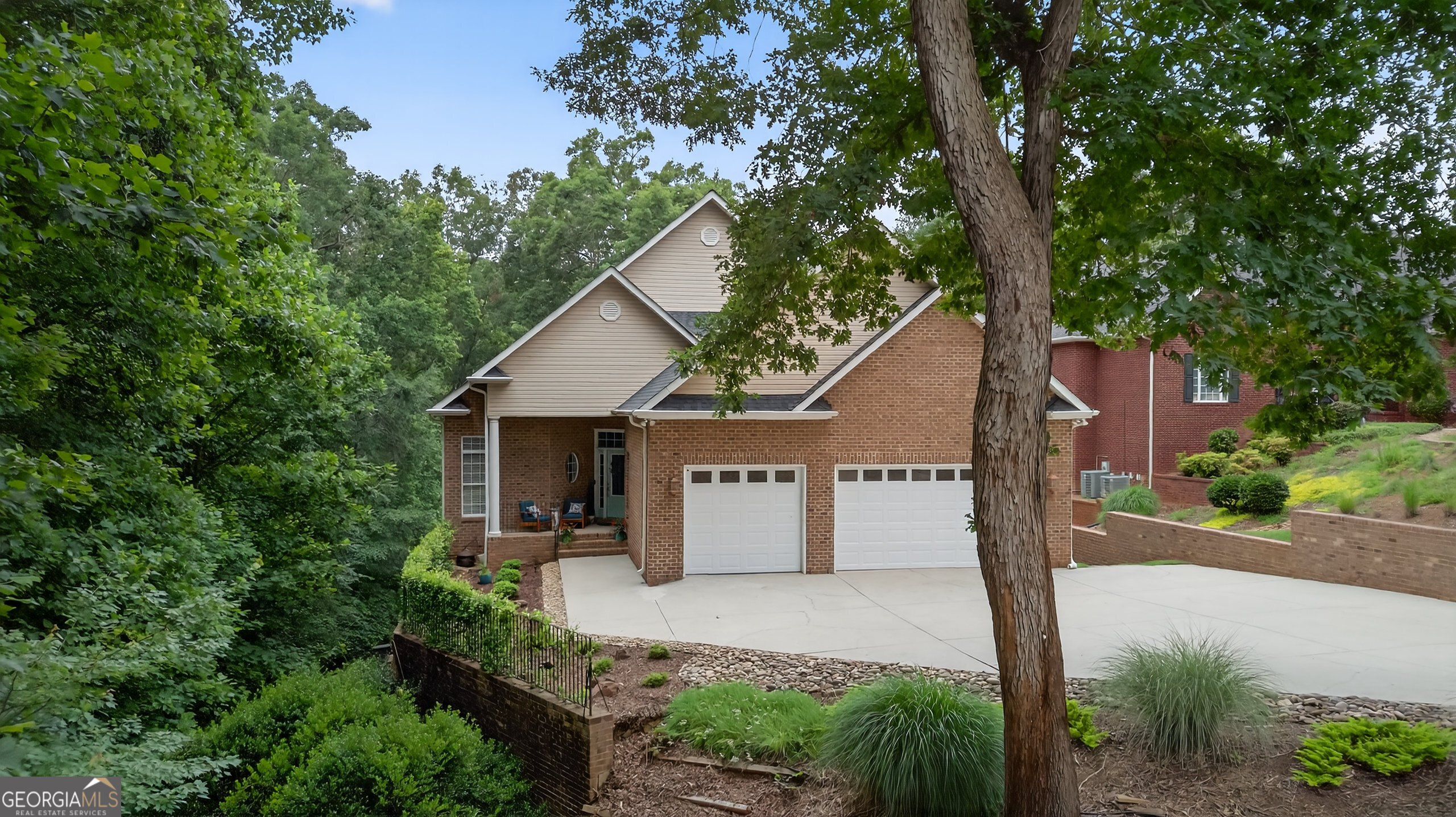 4 sided brick Lake Hartwell waterfront home with nearly 4000 square feet of finished living space! 109 Tall Ship Drive is just 13 miles from Clemson, and those commuting to Greenville can reach their destination in just 40 minutes. It's central location is one of the reasons Lake Hartwell has become the southeast's most popular recreational lake -- we're 2 hours from either Atlanta or Charlotte, and only 4 hours from Charleston. This beautifully maintained home is located in an upscale subdivision in Anderson and is surrounded by other nice homes. This beautifully maintained home is situated on a 0.60 acre lot in an upscale subdivision in Anderson and is surrounded by other nice homes. The main living area is open to the formal dining space and features vaulted ceilings with skylights and a fireplace with gas logs, as well as doors leading out to a large covered porch. The kitchen has both a breakfast bar and an informal dining area, skylights providing natural light, abundant cabinetry, double wall ovens, and a large pantry. Hardwood floors run through much of the main level, and all of the ceilings on this level are 9+ feet high. The main level primary bedroom has a walk-in closet and large private bathroom with double sinks, jetted tub, and separate shower. A second bedroom and full bathroom, as well as a walk-in laundry room are also located on the main level. The finished lower level has an additional large living space with a second fireplace, a wet bar, two bedrooms, a third full bathroom, and a flex space. There is also a large workshop area with a garage door - a perfect place to store a riding mower, golf cart, and more! A concrete path leads to the shoreline where you will find the covered dock with two PWC lifts. This is an exceptional home that has everything you need for full-time living, but would also make a wonderful second home.