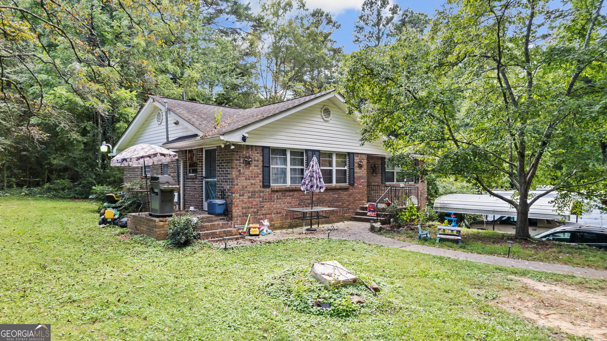 Charming 3-bedroom, 1-bath brick home with hardwood floors throughout, featuring a separate dining room and spacious living room. Located on 1.72 acres per public records of gently sloped land in a peaceful country setting, yet less than 10 minutes from downtown. Modern comforts include central heat and air. Situated in the desirable Model School district. Sold as-is, with a flexible closing date on or after November 1st. Showings require 24-hour notice. There is a shared driveway to the home. Ideal for buyers seeking tranquility with convenient access to city amenities! ***Home is USDA Eligible***