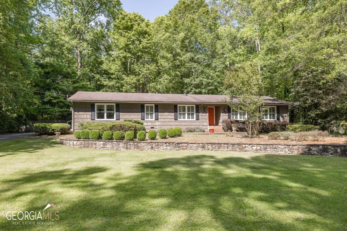 Welcome to 145 Rollingwood Drive, a charming single-story ranch located in desirable Cedar Creek, minutes to east side shopping and downtown Athens. This unique home boasts a spacious floor plan, perfect for entertaining and relaxing with family and friends.As you step inside, you'll notice the newly installed LVP flooring and hardwoods throughout the home, replacing all carpet. The home features a formal living room and dining room with built-in cabinets, perfect for displaying your favorite items. The rear of the home offers a bright and airy eat-in kitchen and den space, complete with sun soaked windows overlooking the backyard. The kitchen has updated cabinetry and granite countertops, while a large laundry/storage room is conveniently located off the kitchen.The converted garage/bonus room with built-ins and plantation shutters provides an additional 400 square feet of living space. On the opposite end of the home, you'll find two secondary bedrooms and two guest bathrooms. The primary suite, located at the rear of the home, includes ample storage and a luxurious ensuite bathroom with a separate, tiled shower and garden tub.Step outside to enjoy the serene backyard, featuring mature plants and trees, a fenced-in backyard with a koi pond, patio space, and brand new decking accessible from the primary suite, eat-in kitchen, and den. 145 Rollingwood Drive is zoned for the upcoming Maxine P. Easom Elementary. This gives you the option, currently, to select from several excellent elementary schools including Whit Davis, Gaines School Road, or Barnett Shoals. Cedar Creek offers a non-mandatory membership to the Cedar Creek Civic Association for $45 per year and a voluntary pool membership for $375 per Season. Don't miss your chance to call this one-of-a-kind home yours!Open House Saturday, May 13th 2:00 to 4:00 pm