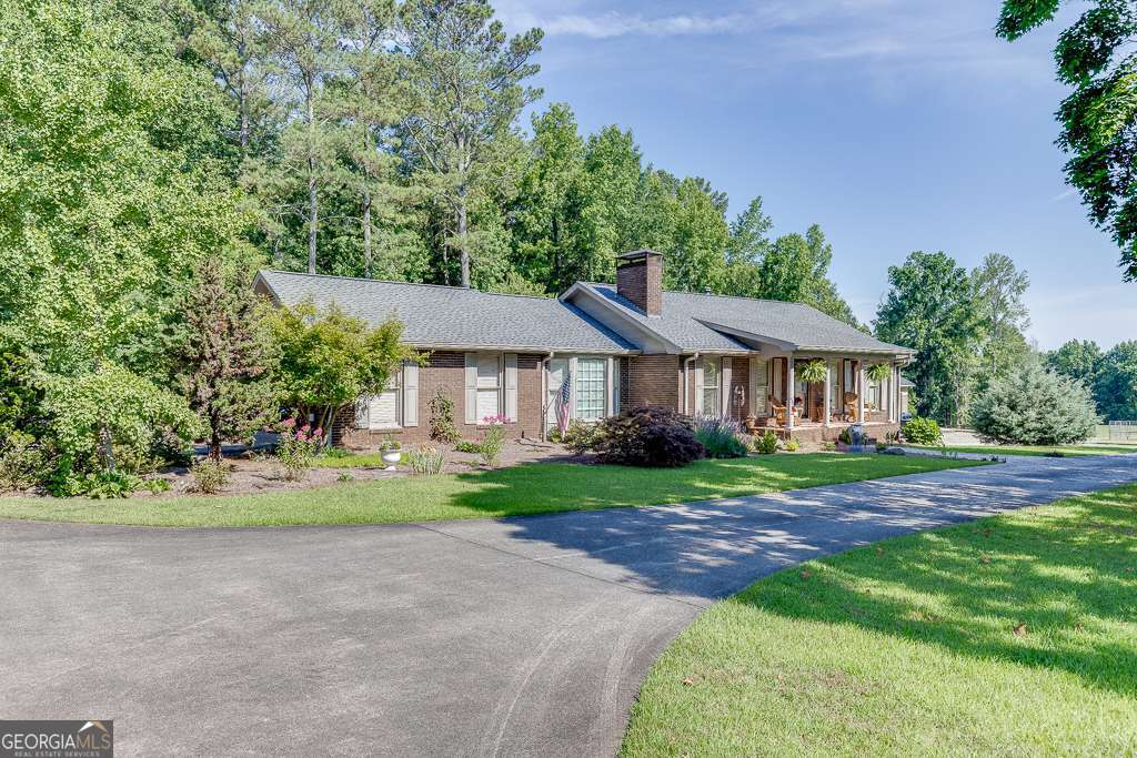 Beautiful 4-sided brick ranch on 35.69 +- Acres, in West Forsyth minutes from the New Publix at Tribble Crossing on HWY 20. This gorgeous home has been meticulously maintained and well built with a 4+/- year old roof and real masonry fireplace. The kitchen is very spacious with great lighting, solid oak cabinets, beautiful granite countertops, large pantry, breakfast area, stainless-steel appliances, and large dining room. The master suite includes a large walk-in closet, sunroom, whirlpool tub and oversized shower. There is a second master bedroom on also located on the main floor which would be great for guests. The full unfinished basement is perfect for storage or could be finished for additional living space or in-law suite. The basement also includes a boat door inro the workshop area that is accessible by the driveway. The exterior features gorgeous flagstone patio, firepit, outdoor kitchen with grill, fridge, sink/ serving station, and low country boil burner for the family gatherings. The property features established rolling pastures with a perfect ratio of wooded acreage and pasture land. The exterior also features a large 35' X 80' detached garage built out of decorative block with 5-10'X10' Garage doors for easy access to the bays. The office portion of the garage is conditioned and includes a bathroom. This is truly a one-of-a-kind property located in West Forsyth!