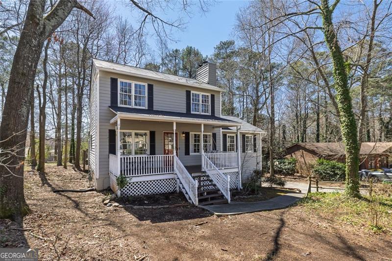 Welcome to 3271 Sutcliffe Ridge NW - a classic Southern charmer tucked into one of Marietta's most beloved communities. Built in 1979, this home blends timeless character with thoughtful updates, starting with the rich real hardwood floors that span the main level. A warm, welcoming kitchen showcases personality-packed cabinetry and opens directly to the back deck through a set of beautiful French doors-inviting you to step outside and enjoy the gorgeous, green, level backyard. The cozy living room centers around a traditional brick fireplace-perfect for relaxing evenings at home-while the formal dining room is ready for special gatherings and holiday dinners. The primary suite is conveniently located on the main floor, offering ease and privacy. Upstairs, you'll find three additional bedrooms and a full bath, ideal for guests, kids, or a dedicated work-from-home setup. Natural light fills the home, from front to back-including a sun-filled bonus room lined with windows, perfect as a reading nook, playroom, or office. Enjoy slow mornings on the covered front porch, where rocking chairs, coffee, and neighborly hellos feel right at home. Out back, the spacious deck is a natural extension of the kitchen, perfect for summer barbecues or simply unwinding with a view of the peaceful yard. The finished basement offers even more space to spread out-think movie nights, a game room, home gym, or creative studio. A one-car garage plus extra storage ensures everything has its place. Beyond the home, the neighborhood is known for its strong sense of community and robust amenities-including a pool, tennis courts, pickleball, basketball, a clubhouse, and a scenic lake with fishing, swimming, boating, and even dock and boat storage. All of this, plus access to top-rated schools, makes this an incredible opportunity to own a home full of charm and potential in a prime Marietta location. Homes like this-at this price-don't come along often!