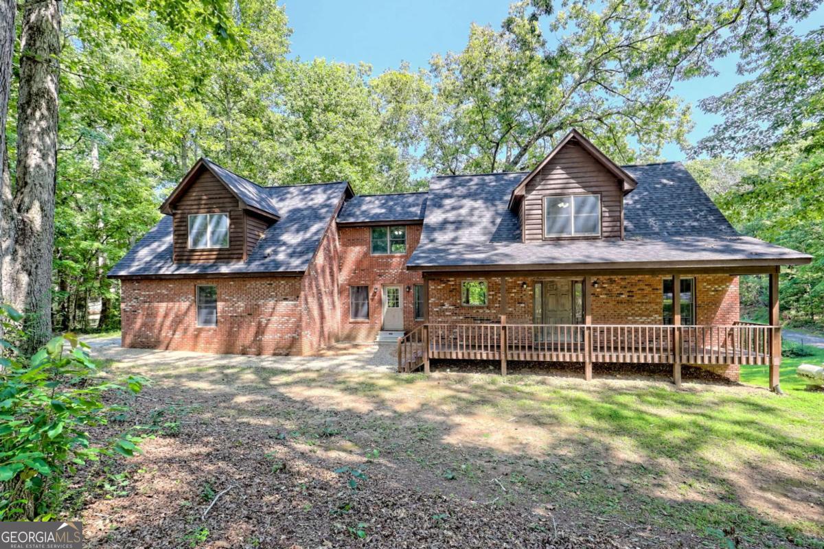 First Time on The Market! Brick Waterfront Home on Lake Chatuge with Permitted Shared Dock on 50' of Frontage. Large Corner Lot For Privacy. Open Kitchen with Pantry, Living Room, Dining room, Den, Abundant Storage. The Upper Level is the Master Suite with Sitting Areas, Multiple Closets, Double Vanity Sinks, Garden Tub. Basement Level Has a Large Open Area, Multipurpose Room, Storage Areas, Full Bathroom, & Mechanical Rooms. Finished Except for the 8' Ceilings. All 3 Levels Open on to Covered Decks. Two Car Garage. INCLUDES A PRIVATE 1/1 Apartment With Living Space, Kitchen, Washer/Dryer. Seasonal Views, Garden Area, Zoned HVAC Systems, New Roof 2025, Newly Painted Inside and Out. Wired For Whole House Generator Too. Convenient to Restaurants, Entertainment, Fairground Activities & More. Enjoy All The Amenities of Lake Chatuge & Marina.