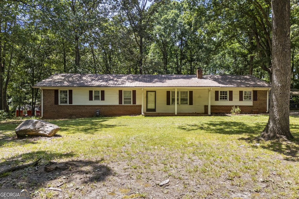 Charming Ranch in the Heart of Madison County! This spacious 4 bedroom, 2 bathroom home is perfectly situated in Danielsville, just minutes from Ila or Hull and only about 12 minutes from Athens! Step inside to an open concept living and dining area with beautiful hardwood floors throughout the main living spaces. The kitchen features stainless steel appliances, ample cabinet storage, and a functional layout perfect for everyday living or entertaining. All bedrooms are generously sized, providing comfort and flexibility for any lifestyle. Enjoy the outdoors on a large lot with mature trees, a great backyard space ideal for a pool, and a recently added back porch, perfect for entertaining guests or relaxing evenings. Additional features include a two car garage, a durable metal roof built to last, and a 5-year-old water heater, outdoor storage shed. Homes like this at this price point don't come around often. Don't miss your chance to make this wonderful Madison County ranch your own!