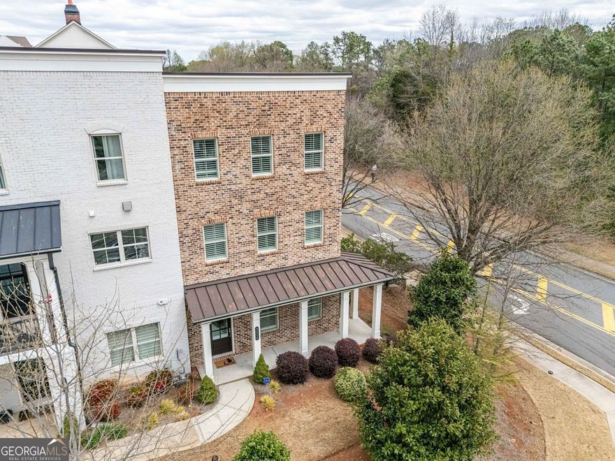 All about lifestyle! Walk from your front door to Amerisbank Amphitheater or North  point Mall. North Point Mall is scheduled for an exciting new re imagining. Beat the rush and get in before the evolution. This is a wonderful end unit designed with an open floor plan.  on the main level enjoy your family room open to the kitchen and dining area. The kitchen features quartz counter tops, double ovens, and stainless appliances. The covered deck is right of this main level and is huge. Great for relaxing or entertaining. Upstairs has 3 bedroom including your en suite master with a large walk-in shower. The first level has a great guest suite with full bath or flex space. Just minutes to Downtown Alpharetta, Avalon, award winning Milton High School and just a 3 Wood away from Top Golf.