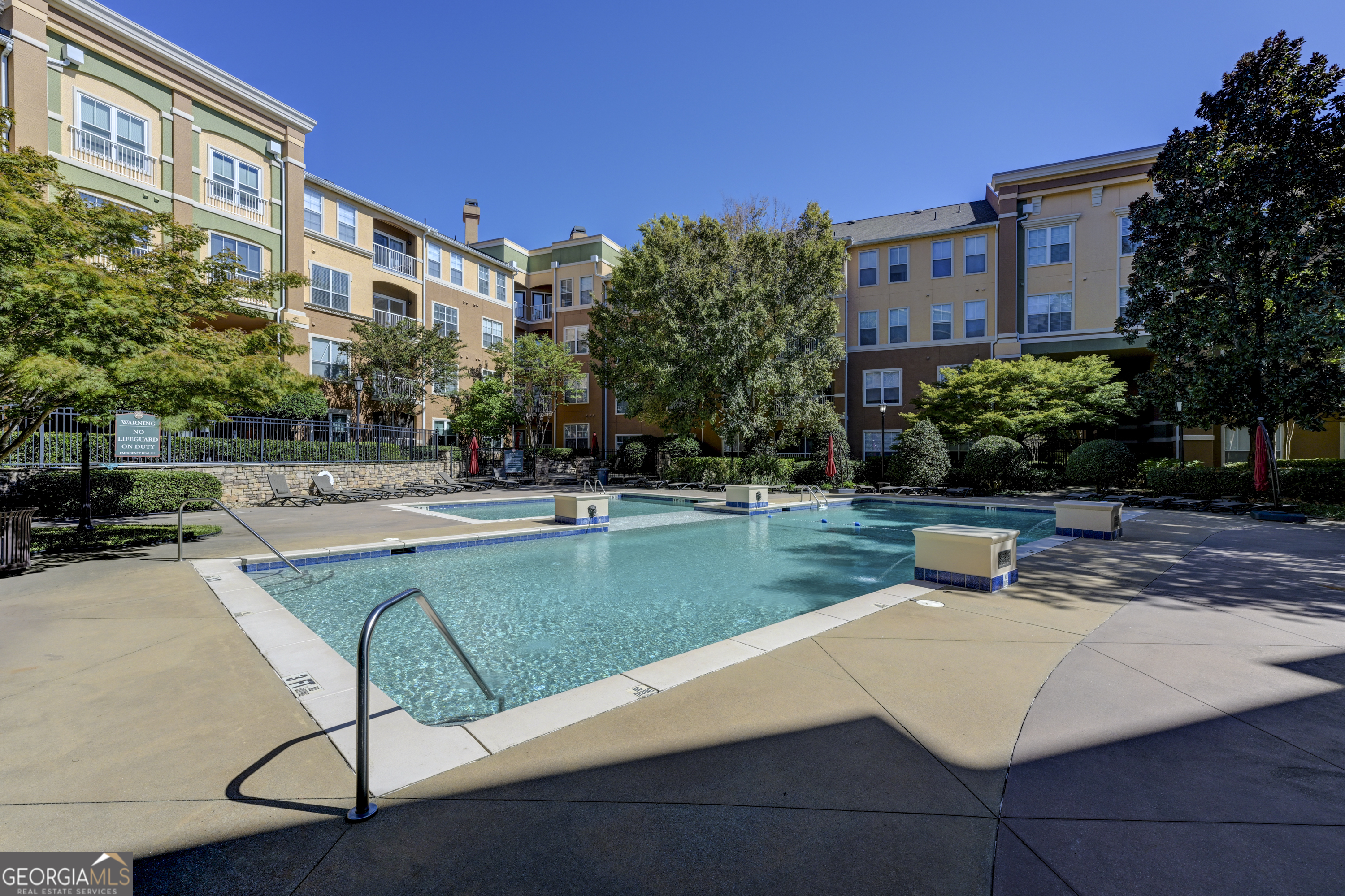 You'll love this meticulously maintained, west-facing, top floor, modern condo unit in Brookhaven's coveted Villa Sonoma community! Space to spread out makes working, studying, or relaxing at home a cinch. Along with the unit come 2 assigned, covered spaces in the attached, gated residents' parking garage - one on the 3d Level accessible by elevator or stairs (375), and one on unit's same 4th Level (491), both super-convenient to unit. Once inside, a white kitchen features stainless steel appliances and double sink with disposal, granite countertops, and breakfast bar. Appliances include a huge side-by-side refrigerator/freezer with icemaker, efficient electric range/oven, microwave and dishwasher. The kitchen opens to a dining area and cozy den featuring crown molding, hardwood floors, tray ceiling with overhead fan, wood-burning fireplace, and a French-door style access to private balcony - which is also accessible from the spacious Master Bedroom. This home's thoughtful layout features 2 bedrooms, 1 full bath, and a convenient hall laundry closet complete with washer and dryer. High ceilings complement beautiful hardwoods, with tons of natural light streaming through ample energy-efficient windows throughout. Villa Sonoma's generous amenities include swimming pool and spa with sundeck, fitness center, business center / clubhouse with catering kitchen, private theatre and billiard/game rooms which may be reserved, and a wooded walking trail. The community is remarkably well-positioned in the heart of one of metro Atlanta's best shopping, dining, office and entertainment districts at the top-end Perimeter! Amidst major thoroughfares I-285, GA-400, Peachtree Dunwoody, and Ashford Dunwoody, you can't beat this FHA-approved condo for convenience to major medical, financial, and retail employers and services. Check with HOA for rental restrictions - could be perfect for an investor. This one checks ALL the boxes -- don't sleep on it if you want to sleep in it!