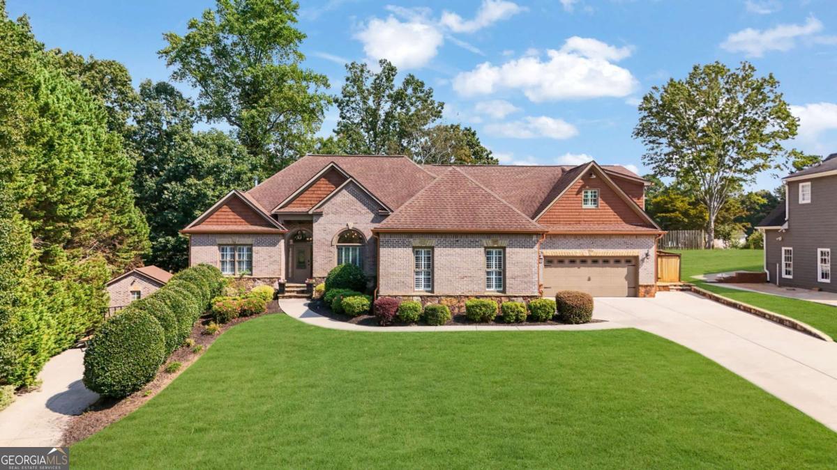 Welcome to 1720 Stillwater Ct. Cumming, GA - just minutes from Lake Lanier, Bald Ridge Marina, shopping, and dining. This spacious brick ranch offers the perfect blend of comfort and luxury w/finished basement and incredible outdoor living. Enjoy your own private retreat featuring a POOL, hot tub w/waterfall, a pool bathroom, OUTDOOR KITCHEN & fireplace - ideal for entertaining year-round. There is an in-law suite or rentable STUDIO APARTMENT above garage with it's own entrance from garage w/full kitchen and add'l laundry room. Car enthusiasts will love the 5 CAR GARAGE & 2 DRIVEWAYS providing plenty of space for vehicles, storage, workshop. Entire kitchen recently remodeled with 48" SUB-ZERO frig, Wolff range w/6 burner cooktop & hood vent, new cabinets and stunning Quartzite c'tops. The garage under the studio apartment is climate controlled.
