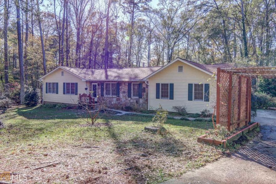 If you enjoy privacy, nature, fruit trees, flowering trees, a gazebo, a fish pond and a creek on your property, do not miss this wonderful property. Granite countertops in the kitchen, remodeled owner's bathroom with marble countertop are among the upgrades. Roof is less than 5 years old. Entire house has recently been painted. An enclosed garage that can be used as a fourth bedroom or office. Approximately half of the large deck is screened in  allowing a lovely view of the woods behind the house. The woods have many trails and a bridge over the creek that runs through the woods. This property has two detached building which both have electricity. A one-year home warranty is included. This is a must see ranch with 3 bedrooms and 2 bathrooms. In addition to the house (Lot 14), the property included with the sale is Lot 11 and 13 (Facing the property, the lot to the left and the lot behind the property extending beyond the creek).  Call today to schedule your tour of this wonderful property.