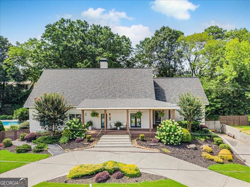 WELCOME HOME to this truly one-of-a-kind estate in the heart of Downtown Alpharetta-now offered at a newly adjusted price! This exceptional all-steel constructed ranch home blends durability with elegance, offering a lifestyle of comfort, space, and unmatched versatility. Step inside to discover a bright and airy open-concept layout on the main level, enhanced by soaring ceilings and abundant natural light. The home features three spacious bedrooms, including a primary suite ready for your personal design touches. Newly updated primary bath. Upstairs, a generous bonus bedroom with loft and full bath provides endless options for a guest suite, home office, or recreation area. Car enthusiasts will fall in love with the expansive garage-room for up to 6 vehicles plus a dedicated workshop area. The 2,970 sq ft unfinished basement (complete with a bath) is a blank canvas just waiting for your vision-whether it's a home theater, gym, or additional living space. Outside, enjoy 3/4 acres of professionally landscaped privacy, complete with a large deck, pool, pickleball/basketball/sport court, and a pool house/storage area-perfect for entertaining or unwinding in your own private retreat. Located in one of North Fulton's top-rated school districts, and just a short stroll to all the shopping, dining, and entertainment that vibrant Downtown Alpharetta has to offer. Priced to sell-this is a rare opportunity to own a home that truly stands apart. Schedule your private showing today!