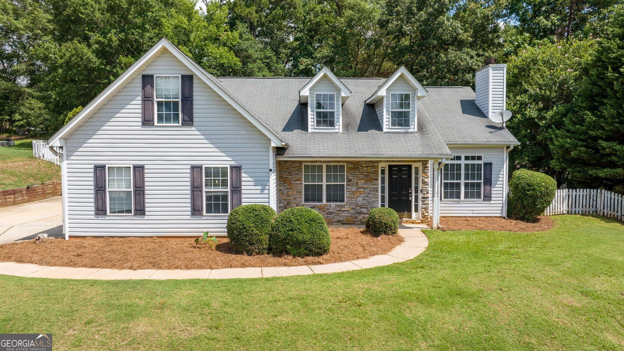 Gwinnett County Bethlehem location! This home features three bedrooms on the main floor, including the master, plus an upstairs bonus room. The living area includes a large great room with a fireplace and an open dining room. The spacious kitchen with an eating area opens to a huge deck and covered entertaining space. Enjoy new flooring and other updates throughout. The property also has a double side-entry garage and a private fenced backyard. Vacant and ready to view with no HOA.