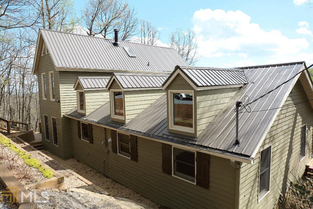 Fabulous view from this Rustic North GA Mountain Retreat in quiet gated community. Features hardwood floors, exposed beams, huge sun room, new large decks w/views to die for, 2 fireplaces plus cozy wood stove. Exceptional amount of upgrades. Lots of room to relax & entertain, close to waterfalls, hikeing trails. Jasper, Ellijay Home just for fun or full time, you can't go wrong. 1.1 acre of privacy, fresh air. 3 BDR 2.5 BA sold with some furnishings.