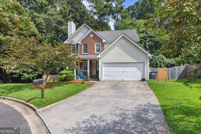 Discover one of the largest floorplans in the swim/tennis community of Woodland Ridge, perfectly situated on a quiet cul-de-sac. This functionally designed home features an open floorplan with gleaming hardwood floors throughout the main living areas. The living room features vaulted ceilings, a cozy fireplace, and custom-built in bookcases. The spacious eat-in kitchen is a chef's delight, complete with granite countertops, a stylish custom backsplash, and ample cabinetry. Step outside onto the back deck that overlooks a private, wooded backyard-your own peaceful retreat. The main floor also includes a guest bedroom with a full bathroom and walk-in closet, perfect for visitors or multi-generational living. Upstairs, you'll find a spacious owner's suite featuring an expansive walk-in closet. Two additional upstairs bedrooms share a Jack-and-Jill bathroom. The fully finished basement is an entertainer's dream! It boasts a custom island bar with cabinetry, stunning epoxy flooring for both style and easy maintenance, and a versatile media/theater room that could double as an extra bedroom. There's also a full bathroom, a private office with charming barn-style doors, and plenty of room for hosting movie nights or game days. Conveniently located just minutes from Marietta Square, Dobbins Air Force Base, WellStar Hospital, and major highways, this home offers easy access to everything you need. Come tour this exceptional property and envision your next chapter in Woodland Ridge!
