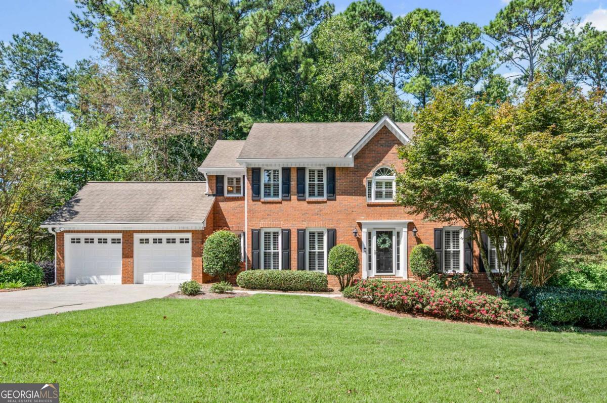 Nestled in the highly sought-after Lassiter High, Mabry Middle, and Rocky Mount Elementary school district, this vibrant community offers something for everyone, an active swim team, year-round tennis, festive seasonal parties, children's parades, book clubs, and more! Step inside this impeccably maintained home and you'll find refinished hardwood floors, crown molding, plantation shutters, and thoughtfully updated finishes throughout. The spacious kitchen is a chef's dream, featuring abundant high-end solid maple cabinetry with soft-close drawers, granite counters, stainless steel appliances and an island with additional storage. The great room is anchored by a stacked stone fireplace with premium gas logs, while recessed lighting on dimmers adds warmth and ambiance. Upstairs, updated bathrooms offer granite counters, soft-close cabinetry and stylish finishes. The cheerful, bright, partially finished daylight basement provides flexible space for growing families, work from home needs, or recreation and entertaining. Walk-out access flows to an expanded patio complete with built-in seating and planters. The unfinished portion boasts a workshop with workbench, sink, and plenty of storage for handy, crafty buyers . One of the true highlights is the private, wooded backyard, an ever-changing backdrop of flowering trees, lush hydrangeas, and a brilliant Japanese Maple. From the custom screened porch which is a favorite living space for all with a gorgeous vaulted, beamed ceiling to the expansive deck, this is a home designed for both quiet mornings with coffee and lively gatherings with friends. Additional updates include new energy-efficient vinyl windows and sliding door with lifetime warranty, Hardie Plank siding with warranty, irrigation system front and back, a wide, level driveway perfect for play or extra parking, two Trane HVAC systems, oversized gutters with gutter guards and a secondary electrical panel with room to grow. Beyond the home, Arbor Bridge is perfectly positioned for convenience, very close to schools, multiple grocery stores, restaurants, entertainment and shopping like the Outlet Mall and Costco, with easy access to the Marietta Square, downtown Roswell, and Woodstock. This is more than a house, it's a lifestyle complete with wonderful neighbors and activities for the whole family.