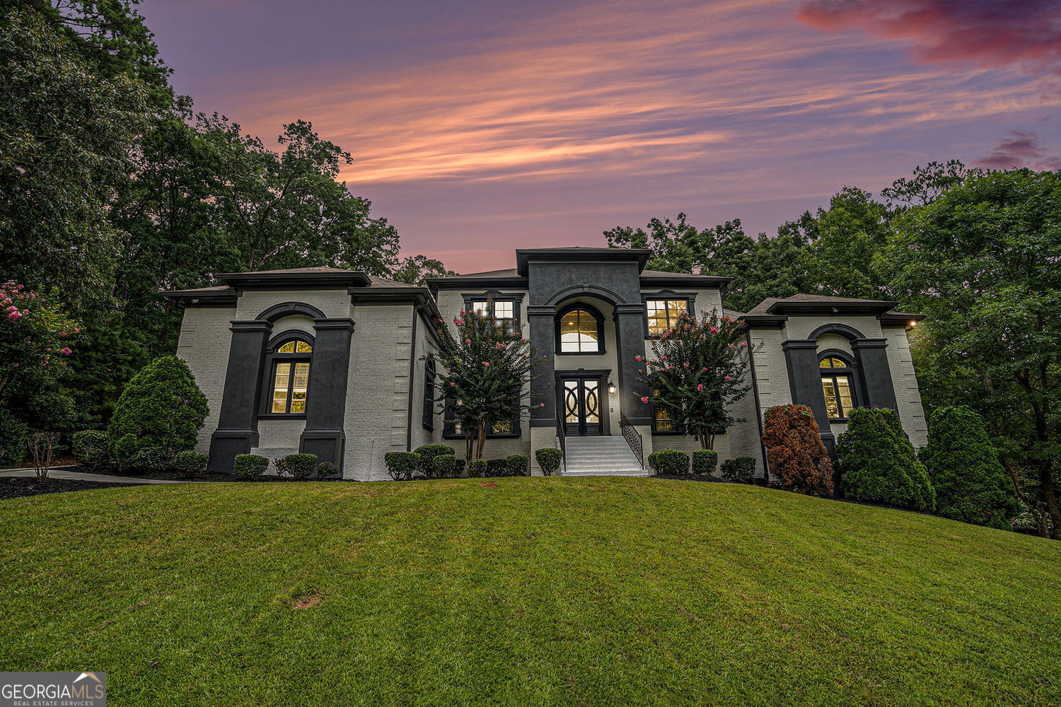 Imagine coming home to a private, gated sanctuary that feels a world away-yet keeps you connected to everything Atlanta offers. Welcome to 4025 Cascade Rd SW, a custom-built estate where 3 levels of refined living meets a lifestyle of elegance, comfort and effortless entertaining. From the moment you step inside, THIS HOME MAKES A STATEMENT. Soaring floor-to-ceiling windows flood the main level with natural light, showcasing a dramatic open-concept design meant for both quiet mornings and unforgettable evenings. The great room, anchored by a commanding stone fireplace, flows seamlessly into formal dining and a chef-inspired kitchen, CREATING A SPACE WHERE CELEBRATIONS COME ALIVE AND EVERYDAY LIVING FEELS EXTRAORDINARY. The Owner's Wing on the main level offers more than a retreat-it's A PRIVATE HAVEN WITH A COZY FIREPLACE, SPA-STYLE SHOWER, AND EXPANSIVE WALK-IN CLOSET. A secondary bedroom w/ensuite bathroom on the main level ensures guests or family enjoy privacy and comfort. Upstairs, 3 more spacious bedrooms and 2 full baths provide versatility, while THE TERRACE LEVEL TRANSFORMS THE HOME INTO AN ENTERTAINER'S DREAM-complete with a theatre room, family room with fireplace, open recreation area, bonus room with full bath, 6th bedroom and a stylish kitchenette with bar. Style it your way and finish out the spa room! Indoor and outdoor living blend seamlessly. Step onto the expansive covered deck, accessible from the kitchen and Owner's Suite, where you can sip morning coffee while listening to the breeze through the trees. Below, the covered terrace-level patio invites you TO HOST EVERYTHING FROM SUMMER COOKOUTS TO GAME-DAY WATCH PARTIES-all while overlooking your private, tree-lined 1.027-acre lot. This estate's lifestyle extends far beyond its walls. Just minutes away, explore the trails of Cascade Springs Nature Preserve, enjoy afternoons at West Cascade Park or Melvin Park, or take advantage of Atlanta's thriving dining and cultural scene in nearby Downtown and Midtown. For jet-setting professionals, Hartsfield-Jackson International Airport is within easy reach, offering seamless travel access without compromising on privacy. With 6 bedrooms, 5.5 bathrooms, 4 fireplaces and a 3-car garage, THIS RESIDENCE BALANCES SOPHISTICATION WITH WARMTH, MAKING IT EQUALLY SUITED FOR ELEGANT ENTERTAINING AND EVERYDAY LIVING. 4025 Cascade Rd SW isn't just a home-it's a story waiting to be lived.