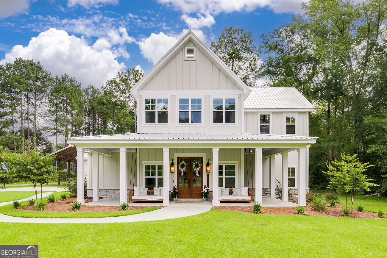 "A Honey Of A Farmhouse" - Like New Resale on 5 Acres in Effingham County! This exceptional custom-built home by Cypress Customs LLC is a rare opportunity to own a barely-lived-in modern farmhouse retreat, originally completed with meticulous attention to detail. Nestled on 5 private acres, this showstopping residence offers the perfect blend of upscale finishes and timeless character. Designed with an open-concept floor plan ideal for entertaining, the home features a dramatic two-story wood-burning fireplace with a stone surround, wood beams, and high-end LVP flooring throughout. The gourmet kitchen impresses with custom cabinetry, quartz countertops, a classic white Kohler farmhouse sink, and premium appliances. Craftsmanship shines through in the custom trim package, antique-style touches like a transom-topped laundry room door, and unique architectural elements reclaimed from the original early 1900s home once on the property. These include exposed antique beams, original interior doors, reclaimed brick accents in the powder room, and charming wall-mounted cast iron sinks. Modern conveniences like energy-efficient spray foam insulation pair seamlessly with rustic elegance. The result is a home that feels brand new but carries a sense of history and warmth that new construction simply can't replicate. Truly one-of-a-kind in Effingham County-this luxury farmhouse offers style, space, and serenity, just waiting for its next chapter. Schedule your private showing today-this gem won't last long!