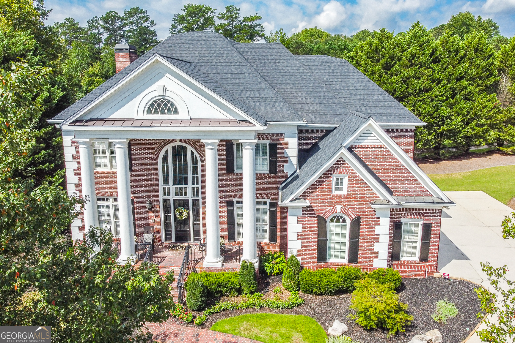 HONEY STOP THE CAR!! UNBELIEVABLE PANORAMIC VIEWS OF 3RD FAIRWAY JUST BEGINS TO DESCRIBE THE EXCITEMENT THIS STUNNING NEW SUGARLOAF LISTING BRINGS... Massive tall, thick columns- reminiscent of The White House, greet you to this Georgian/ Charlestonian architectural style home... Spotless immaculate in care (and pet free), enter home to two-story foyer with heavy trim... Private paneled home office; HUGE formal dining room to fit 12; custom glass-shelved liquor/ beverage wall. Butler's pantry with ice maker. Elegant Grand Room with wide-open golf views... Gourmet kitchen with double-ovens and all the features that the best of chefs would desire... Easy walk-out from kitchen leads to very entertaining deck. Upper level of home is VERY unique- all bedrooms with own private bath suites. Master up suite features: beautiful gas-starter fireplace; sitting room; HUGE HUGE master BR walk-out balcony overlooks all the golf action! And lastly, large owner's closet... Terrace level is handsomely finished featuring: Billiard/ pool room; second Grand Room or media room; bedroom; full bath; kitchen/mini bar; and storage center with electronic home center. Some add'l features to this home: Instant whole-house hot water system; 50-yr high performance architectural roof; epoxy-coated 3-car garage- looks like a Porsche showroom! Whole-house electronic surge protection system; dry-under deck system; whole-house music network. All TVs remain; top-quality washer & dryer remain; all refrigerators remain... Superior all-brick construction. And located in the heart of quiet cul-de-sac. PRICED TO SELL!!! World-class country club guard gated community boasting famous Greg Norman signature 27-hole TPC golf; 60,000 sq ft clubhouse; numerous restaurants; stunning swim/ tennis/ gym facilities; and dozens of year round social & athletic activities. Showings begin Monday the 18th...