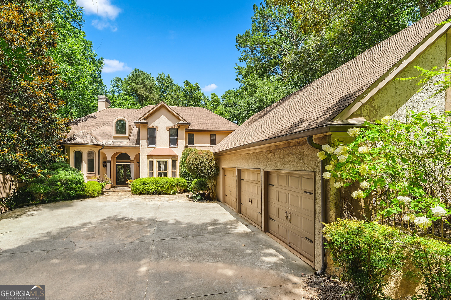 Welcome to a rare blend of luxury, comfort, and natural beauty-nestled on 1.3 private, manicured acres with panoramic views of the 5th hole and fairway of the prestigious Towne Lake Hills North Golf Course. This stunning traditional home offers a lifestyle of serenity and sophistication, where every detail has been thoughtfully designed for both relaxation and entertaining. As you approach, the peaceful charm of the front courtyard sets the tone. Picture yourself sipping morning coffee to the soft sound of a bubbling fountain, while watching golfers pass and deer wander nearby. This tranquil space, coupled with a sparkling heated pool in the backyard, creates the perfect backdrop for everyday peace and unforgettable gatherings. Step inside and immediately feel the warmth and openness of the main living areas. A wall of windows floods the space with natural light and draws your eyes to the breathtaking views of the sand trap, trees, and rolling greens. The open-concept floor plan connects the living room seamlessly to the expansive deck, ideal for hosting or simply enjoying the stillness of nature. The heart of the home-the gourmet kitchen-is a dream come true. Featuring a massive island perfect for family meals or entertaining guests, this space flows effortlessly into the cozy breakfast area and keeping room with fireplace. Whether you're hosting holiday dinners or enjoying casual weekends, this kitchen will become your favorite gathering spot. Retreat to the luxurious mainlevel owner's suite, a peaceful sanctuary complete with a sunken sitting area and private views of the golf course and surrounding landscape. Unwind in the spa-like en-suite bath and wake up every morning to views that inspire calm and clarity. Upstairs, three generously sized bedrooms each offer their own private bathroom, giving everyone their own space and comfort. On the lower level, the fully finished terrace expands your living and entertaining possibilities. A large family room with wet bar is perfect for game nights, movie marathons, or weekend fun. You'll also find a workout room, billiards area, and three flexible rooms ideal for guest bedrooms, offices, or creative studios. The 3-car garage includes a hidden gem-an unfinished carriage house above with plumbing and electrical already in place, offering potential for a guest suite, studio, or income property. As part of the vibrant Towne Lake Hills community, you'll have access to resort-style amenities including tennis courts, a pool with waterslide, gym, playground, clubhouse, restaurant, and optional golf club membership. Whether you're an avid golfer, a nature lover, or someone seeking peaceful luxury in a thriving neighborhood, this home offers it all. Come experience the lifestyle you've been dreaming of-every day feels like a getaway in this extraordinary home.