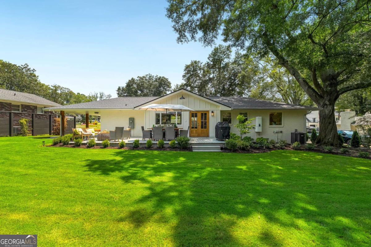 A Rare Garden District Gem - Brand New Build, Timeless Luxury! Welcome to a masterfully rebuilt and expanded single-level home in Alpharetta's sought-after Garden District-where timeless craftsmanship meets modern design. Completely reconstructed down to the foundation and issued a Certificate of Occupancy, this home is move-in ready for a quick close. From the moment you arrive, the attention to detail is undeniable. Casement windows and Mahogany Honduras doors flood the interiors with natural light, while designer lighting and red oak hardwood floors create a warm, elegant atmosphere. At the heart of the home, the chef's kitchen impresses with a Thermador 6-burner gas range, Fisher & Paykel refrigerator, and custom-milled 300-year-old white oak cabinetry finished with handmade hardware. A custom FOBEST fabricated vent hood from the Pacific Northwest Corporation and quartz countertops complete this true culinary showcase. The floor plan offers three bedrooms and three full baths, including a primary suite with a freestanding soaking tub and walk-in shower. The third bedroom is designed for versatility, doubling as a home office with a built-in double Murphy bed for guests. This home is built for peace of mind, with new plumbing, wiring, buried power lines, commercial-grade copper piping, dual water lines to the meter base, and a brand-new sewer line with a backflow preventer valve. Additional upgrades include a tankless gas water heater, whole-house water filtration, blown-in Celsius insulation, a new architectural shingle roof, and a brand-new, high-efficiency HVAC system. Step outside to a professionally landscaped, flat backyard, featuring a Sequoia tree sourced from California's Sequoia National Forest and a full irrigation system - front and backyard. A one-car carport and walkable access to downtown Alpharetta, Avalon, the Alpha Loop, dining, shopping, and GA-400 complete this exceptional property. This is more than a home-it's a statement of craftsmanship, design, and location.