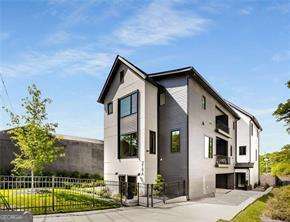 DRASTIC Price Reduction PLUS $10K in Closing Costs or Rate Buy-Down to Buyer at Closing! Even sweeter, lock in a 3.99% interest rate and live your best life in the heart of Reynoldstown. This like-new 3BR/3BA fee-simple modern beauty delivers unbeatable value with no HOA fees and a prime location just steps from the Atlanta Beltline, Krog District, Memorial Drive's Miracle Mile, and a vibrant mix of shops, restaurants, parks, and neighborhood favorites. Spanning three spacious, light-filled levels, the home perfectly blends elevated design with everyday functionality. High-end finishes are found throughout, including site-finished hardwood floors, custom cabinetry, hand-crafted tile baths, sleek Jenn-Air appliances, elegant Visual Comfort designer lighting, and remote-controlled blinds from The Shade Store that combine both style and ease. The chef's kitchen is a showpiece with its dramatic oversized stone island, bespoke vent hood, and seamless flow into the open-concept living and dining spaces-ideal for entertaining or enjoying the comforts of home. Multiple outdoor living areas include a covered balcony off the main level for morning coffee or happy hour, a private terrace off the serene primary suite, and a professionally landscaped, fully fenced front yard perfect for gardening, relaxing, or pets at play. Additional highlights include a welcoming foyer entry, smart home security with video surveillance, and a two-car rear-entry garage with extra storage. Stylish, secure, and within walking distance to everything, this is a rare opportunity to own a modern retreat in one of Atlanta's most dynamic and walkable neighborhoods. Don't miss it!