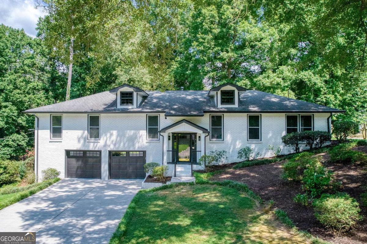 JUST LISTED IN EAST COBB! POPE HIGH SCHOOL! MOVE IN READY! Welcome to this beautifully refreshed one level living home located in the heart of East Cobb, just minutes from top-rated schools, shopping, dining, and more. This spacious residence is nestled in a quiet, desirable neighborhood on a corner lot. The family room has vaulted ceilings with a skylight for abundant natural light, while the separate formal living and dining rooms offer versatile entertaining spaces. The lower level includes a huge recreation room which would be a perfect theater/entertainment/playroom area. Finally, enjoy year-round relaxation in the glass enclosed sun room that overlooks a large, private backyard. The attached deck and patio make it perfect for entertaining or quiet evenings enjoying the beautifully landscaped yard. Located in the POPE HIGH SCHOOL district, this turnkey home offers both style and convenience. Come see this beauty today!