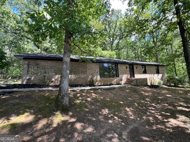Beautifully renovated brick home - feels brand new! Step inside this classic 4sided brick residence and enjoy a fresh, modern interior that lives like new. Thoughtful updates begin in the heart of the home - the kitchen - where crisp white cabinetry, gleaming granite countertops and brandnew stainless steel appliances make cooking a joy. A nearby laundry/mud room includes a modern washer and dryer and opens to an expansive backyard, making daily chores easy and offering a seamless flow for indooroutdoor living. The layout features hardwood floors and abundant natural light. A brick fireplace anchors the main living area, and a separate formal living/dining room provides flexibility for entertaining or a quiet home office. Three comfortable bedrooms include a primary suite and two pristine, completely updated bathrooms with contemporary finishes and allnew fixtures and lighting. Every room has been freshly painted, and updated lighting throughout gives the home a bright, inviting feel. Outside, the large yard offers plenty of space for gardening, play or future expansion, while the clean carport with an attached utility closet keeps tools and bikes neatly tucked away. Set in the established Kingswood area of Athens, you're minutes from schools, parks, shopping and the University of Georgia. Don't miss your chance to own a likenew home in this soughtafter community. Schedule your showing today and experience the quality of this renovation for yourself!