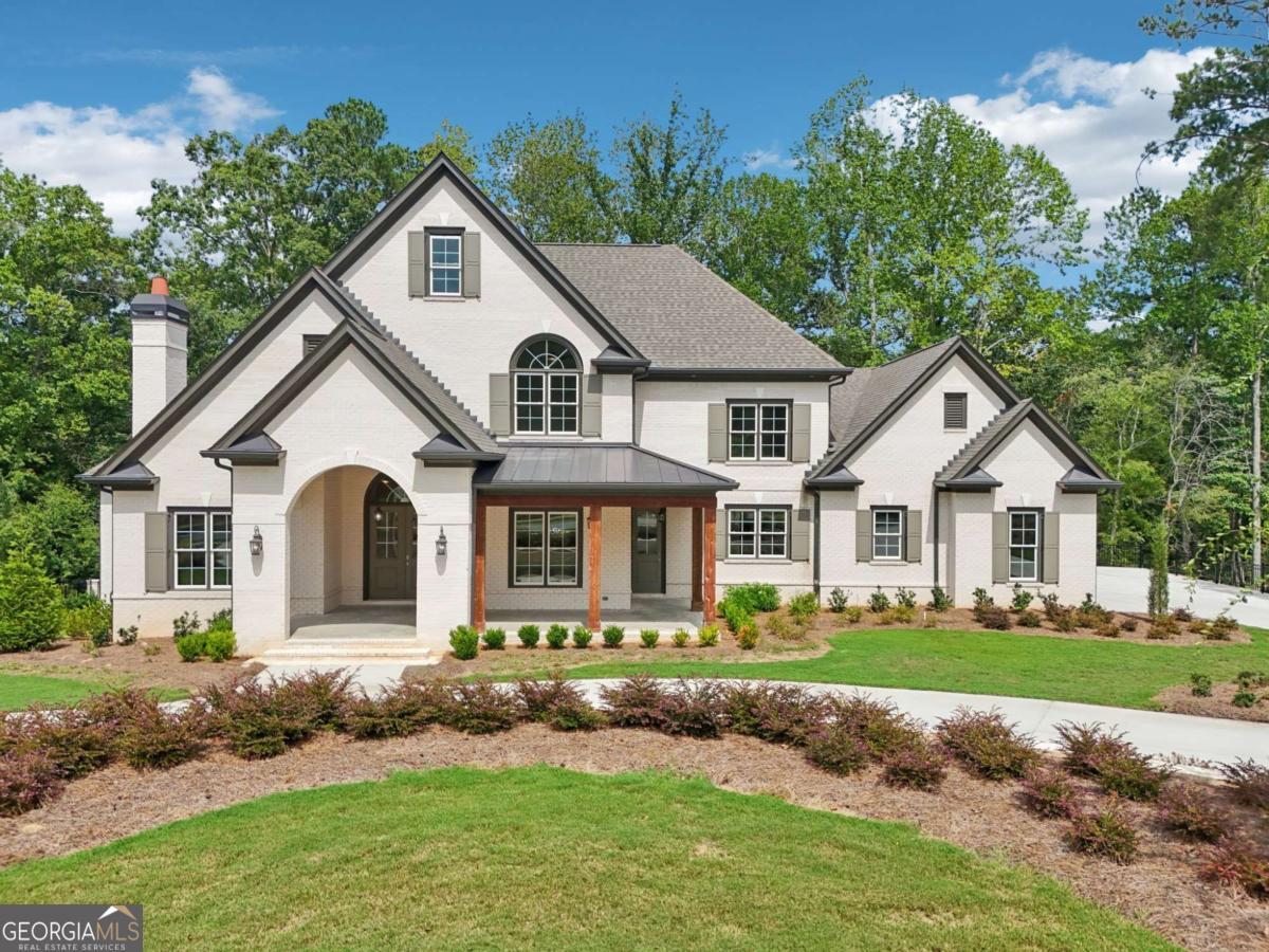 Discover one of the most exceptional locations in Governors Towne Club-this custom-built, impeccably crafted home sits on an extraordinary lot with sweeping views of hole #5 in the front and the tee for #6 just beyond the private back porch. From the moment you arrive, the painted-brick facade, stately arched entryway, and tongue-and-groove ceilings set the tone for timeless elegance. Inside, gleaming hardwoods lead through a soaring coffered-ceiling great room with fireplace, while the gourmet kitchen boasts an oversized quartz island, pro-grade range and hood, walk-in pantry, and butler's pantry to the formal dining room. The main level also features a private office with fireplace, screened porch, and an opulent primary suite with porch access, dual custom closets, soaking tub, and frameless shower. Every bedroom is a private en-suite with walk-in closet. Outdoor living includes a covered front porch, screened porch, open-air deck, and covered terrace with serene, never-to-be-disturbed views. A horseshoe driveway, 3-car garage, and professionally landscaped grounds complete the picture. Built by a highly reputable local builder, this home includes the seller-paid $30,000 Governors Towne Club initiation fee-your gateway to a vibrant social membership with access to world-class amenities including a resort-style pool with waterslide, full-service spa and fitness center, tennis and pickleball courts, clubhouse dining, year-round social events, and the peace of mind of 24/7 gated security with a staffed guardhouse. Thank you for scheduling your tour-this is a home and community experience you'll never forget.