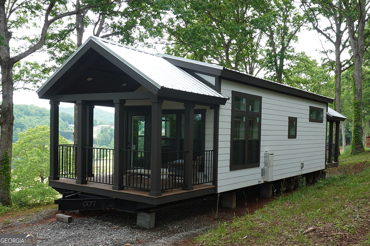 Discover the charm and convenience of this fully upgraded 2023 Cahaba Model tiny home located on Lot #17 in Peaceful Meadows-a thoughtfully designed Tiny Life Village just outside of Franklin, NC. This 395 sq ft, 13' x 47' RV park model offers 1 bedroom, 1 bathroom. Nestled on a 0.37-acre lot, this home is filled with premium features and stylish finishes. Enjoy quiet country living with all the modern conveniences in this growing tiny home community.Peaceful Meadows spans 28 acres and will feature 78 homes at completion. Residents enjoy a peaceful, community-oriented lifestyle with modern amenities including paved roads, water, septic, high-speed internet, and professionally maintained landscaping in shared green spaces. Future amenities under development include: * Gated entrances * Clubhouse with fitness room & pavilion * Picnic area * Pickleball court * Dog park Please note: Home is not available for occupancy until utilities are installed and final setup is complete-estimated move-in ready by early July 2025. Active construction site - use caution when visiting.
