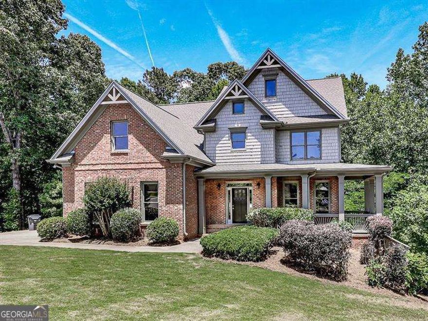 Gorgeous Craftsman Style Executive Home on Cul-De-Sac sits on almost 1 Acre Wooded Private Lot with Gentle Running Creek. Finished basement with 2 bedrooms, bath and full kitchen and second laundry room!  Lovely Brick and Cedar Shake Front Accent, 2-Car Side Entrance Garage, and newer 30-Year Architectural Shingle Roof. Impressive 2 Story Entrance Foyer, Lovely Refinished Hardwood Floors & Gourmet Kitchen with imported Italian Cabinets, Granite Counters, Stainless Steel Appliance, Tiled Backsplash and Huge Kitchen Island with Separate Breakfast Area. Spacious Dining Room and with Stacked-Stone Double Sided Fireplace between Large Family Room and Kitchen. NEW CARPETS AND INTERIOR PAINT THROUGHOUT. Laundry Room on Main. Large Master Bedroom with 'Owner's Retreat' Private Living Room. Master Bathroom features Dual Vanities, Jetted Soaking Tub, Separate Shower, Ceramic Tiled Floors, and Walk-In Closet. Spacious Deck off Main overlooking private wooded backyard. HUGE Unfinished Basement with 12' Ceilings, Stubbed, Daylight Windows and Exterior Access. Great Finishing Potential. Beautifully Well Established and Maintained Neighborhood with Resort Style Amenities Featuring Pool with Slide and Mushroom, Club House and 2 Lighted Tennis Courts. Great Forsyth County School. Close to Little Mill Middle School, GA 400, Northside Forsyth Hospital, and Market Place Shops in Cumming and only minutes to Lake Lanier.