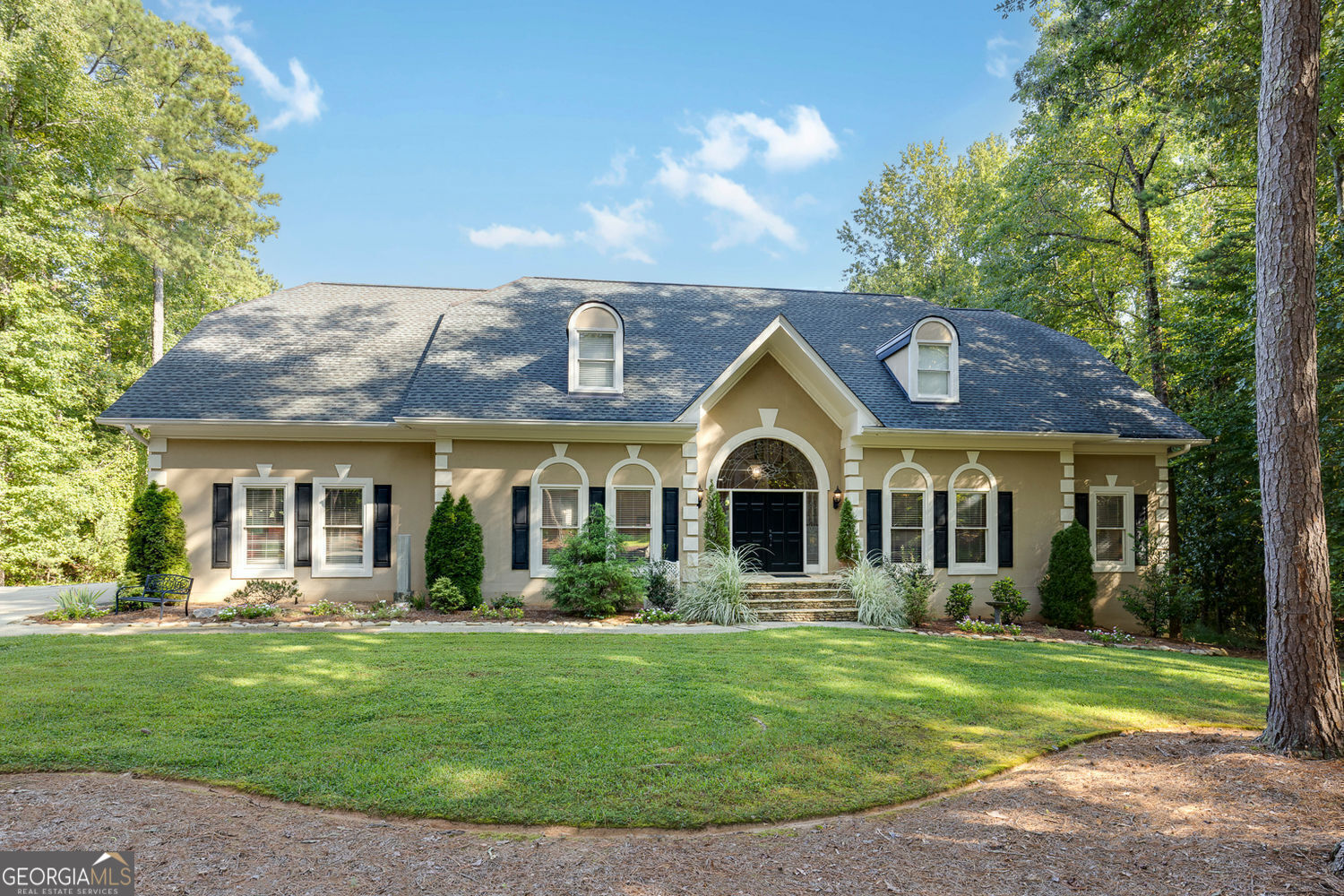 Rare Dual-Residence Estate in Roswell! Discover an extraordinary opportunity to own a private, 2-acre estate tucked away on a quiet cul-de-sac in one of the area's most prestigious communities. This unique property features two fully independent residences. The Main Residence offers 6 bedrooms and 5 baths and the Detached Second Residence has an additional 4 bedrooms and 4.5 baths. This estate was designed for large families, true multi-generational living, guest accommodations, or income-producing investment potential. It offers serene views to a shared backyard sanctuary where birdsong, gardens, and a resort-style pool & spa create everyday tranquility and exquisite gathering spaces. Main Residence - 3,965 sq.ft: The dramatic two-story foyer welcomes you into a home designed for both comfort and entertaining. Featuring a banquet-sized dining room, paneled study, and renovated chef's kitchen with quartz countertops and stainless-steel appliances. The kitchen opens to a bright eat-in breakfast area, an air-conditioned sunroom, and a soaring great room with fireplace, all leading to a brand-new expansive deck perfect for outdoor gatherings. This elegant home includes dual primary suites, one on the main level and one upstairs each with newly renovated bathrooms and generous walk-in closets. There's an additional bedroom on the main level and two more bedrooms upstairs, ensuring flexible space for large families or guests. The finished terrace level opens to the pool area and is an entertainer's dream, with a media/game room, full wet bar, an additional bedroom/office and a very large 400 sq.ft. air-conditioned workshop or hobby room with exterior access (not included in total sq.ft.). Detached Residence - 2,690 sq.ft.: The beautifully designed second residence provides complete privacy and independence from the main residence and offers a traditional layout with vaulted ceilings and a fully renovated kitchen with quartz countertops and a 7 ft. island. The dining area flows into the open-concept living area with a fireplace which leads to its own expansive deck overlooking the nature-rich grounds. The main floor boasts two primary suites (including one with its own sitting area and exceptional closet space), each with private baths. Upstairs on the 2nd floor, you will find two additional bedrooms and one full bath, providing comfortable separation of space. Resort-Style Amenities: Both residences are oriented to a serene, nature-rich shared backyard with a fenced custom-finished pool and waterfall spa that is accompanied by a dedicated pool bathroom. There is over 2,000 sq ft of Trex decking, on 2 separate decks each having beautiful views of the grounds. There is a three-car air-conditioned garage, plenty of parking and lots of green space with a storage shed, seating area, and room to grow. Additional upgrades include professional landscaping with smart sprinklers, smart pool controls, and smart lighting. The backyard, framed by mature trees and dappled light, is ideal for entertaining, hosting large gatherings, or just enjoying morning coffee beneath the shade of the covered patio watching the butterflies and songbirds as deer wander the edge of the lawn. Afternoons drift by beside the pool. Evenings settle around soft landscape lighting and the quiet hum of nature. Location: Located just minutes from Historic Roswell, Trendy Alpharetta, and Atlanta, this property lies within a top-rated public school district and near a sought-after private school. While offering easy access to a large City of Roswell Park with a dedicated dog park, shopping, dining, and entertainment, this estate feels secluded yet offers the perfect blend of privacy, luxury, and convenience. If you are looking to host and live close to your extended family, entertain in style, or enjoy the flexibility of rental income while living in luxury, this versatile estate is ready to exceed every expectation as your everyday retreat that feels a world away.