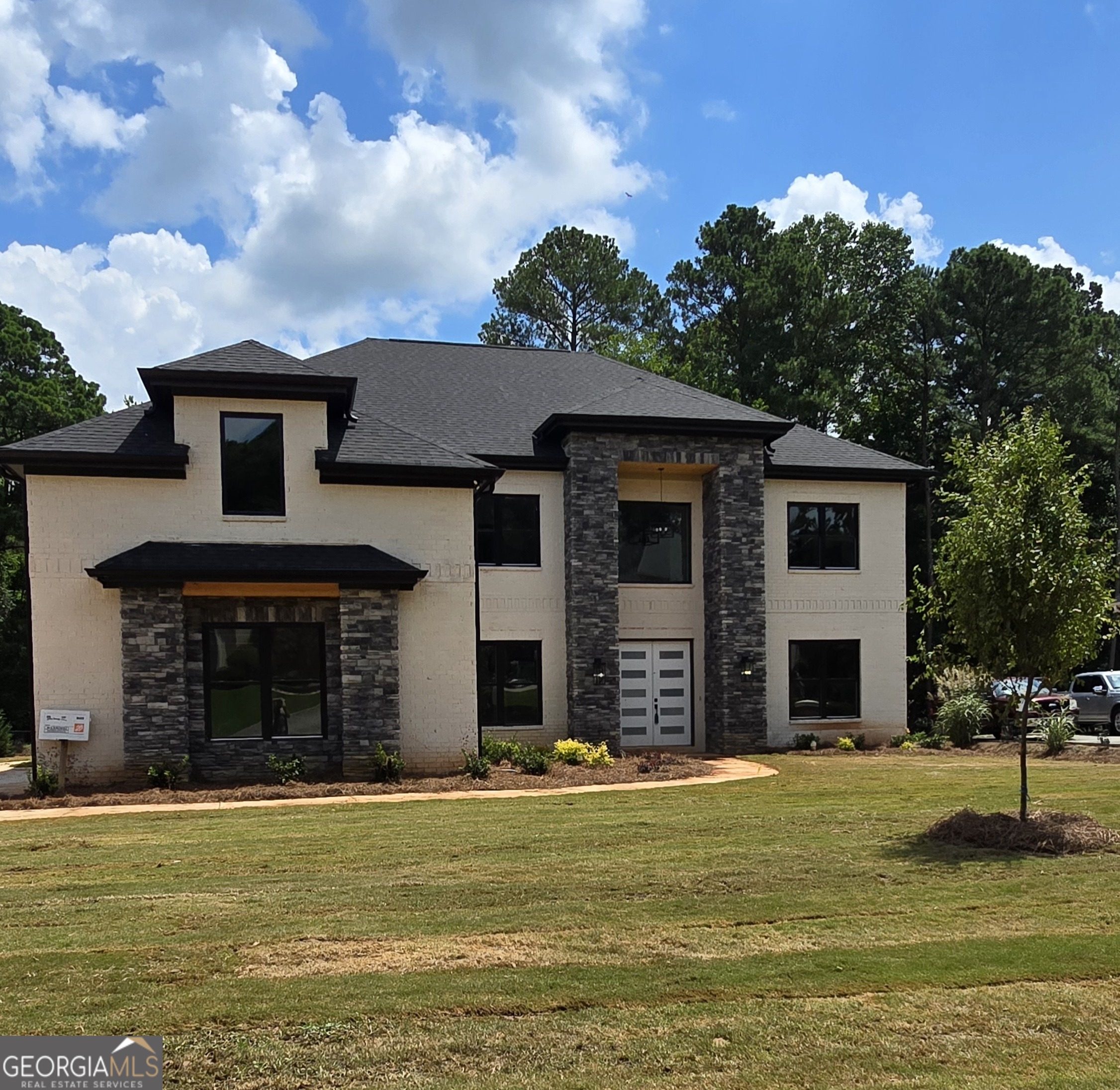 *** Builder Special up to 10k toward closing cost with preferred Lender***  Welcome Home to this STUNNING Custom Built of 4-Sided Brick & Stone accent with Black Windows. This New Construction of 5BR/5-1/2BA is nestled in the Davidson Arabia Nature Preserve area, with close proximity to Interstate 20, and conveniently accessible to Decatur, Atlanta, Conyers and Interstate 285. QUINTESSENCE LUXURY Living a REALITY!! The Double Front Doors Swing open into the 2 Story Foyer with Jaw dropping Chandelier as you are Ushered into Custom TRIM Works that you Only see in Magazines. Open Concept with Hardwood Flooring throughout the house with tiles in the bathrooms, (NO CARPET)! The Open Formal Dining and Living Room is Perfect to Entertain Guests. Watch Family Hang Out in the 20' Double Tray Ceiling Family Room with Contemporary Fireplace, and Floating Shelves for Decor & Portraits. The Chef's Dream Kitchen will motivate you to prepare dinner for either a small or large gathering. It features: Quartz Counters with a Waterfall Island, Pot Filler, Custom Cabinetry, Spacious Breakfast Area with Super-Sized Walk in Pantry. The Office/Study on the main level is tucked away to provide the peace and quietness needed for work at home or meditation. Across the Interior Balcony on the Second Floor, is a Solid Panel French Doors that leads into The Luxurious 10' Double Tray Ceiling Owner's Suite with an Oversized Sitting Area for Comfort and Relaxation. The Lavishly apportioned Master's Bathroom is Enhanced with Frameless Walk in Glass Shower, Separate Tub, and Porcelain. The 238 Square Feet Walk in Closet Guarantees Room for each Season. The Secondary Bedrooms are Ensuite with Frameless Glass Tiled Shower. Enjoy the Extra-Large Covered Patio Overlooking Nature in the Privacy of Professionally Landscape Backyard. The Private Driveway that leads to the 3 Car Garage offers Plenty of Parking for Guests.  This Astonishing Custom Home is A MUST SEE!!! The house is currently under construction near completion. In the interim, enjoy STOCK PHOTOS FROM THE SAME FLOOR PLAN RECENTLY COMPLETED. FINISHING MAY REFLECT MINOR DIFFERENCES.   The floor plan is available upon request.  The house is currently under construction near completion