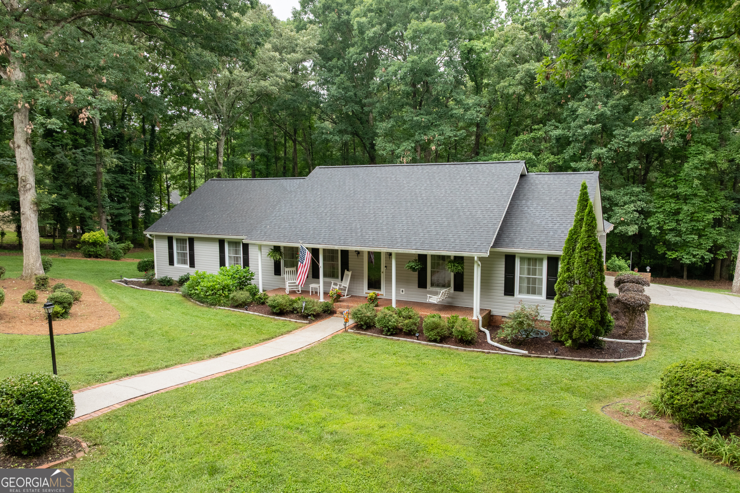 Located inside the city limits on a quiet corner lot, this traditional ranch-style home offers comfort, convenience, and charm. Just minutes from grocery stores and restaurants, the home features a welcoming covered front porch, a brick-lined walkway, and a spacious, flat yard with a new privacy fence (installed 11/2024). Enjoy outdoor living year-round on the large screened-in back porch, upgraded with Trex flooring, built-in cabinets, and countertop space. The fenced backyard also includes a shed for extra storage, plus two storage cabinets on the carport. Inside, you'll find 4 bedrooms with new carpet (installed 6/2025), a separate laundry room, and three hot water heaters so you'll never run out! Enjoy peace of mind with a new 25-year shingle roof installed July 2024. The underground sprinkler system is connected to a private well, helping maintain the lawn with ease. City water, sewer, free trash pickup, and proximity to emergency services add even more value. Police, Fire Department, and Hospital are within 2 miles while Fort Mountain State Park and Carters Lake are nearby as well. This well-maintained home blends traditional style with modern updates. Schedule your showing today!