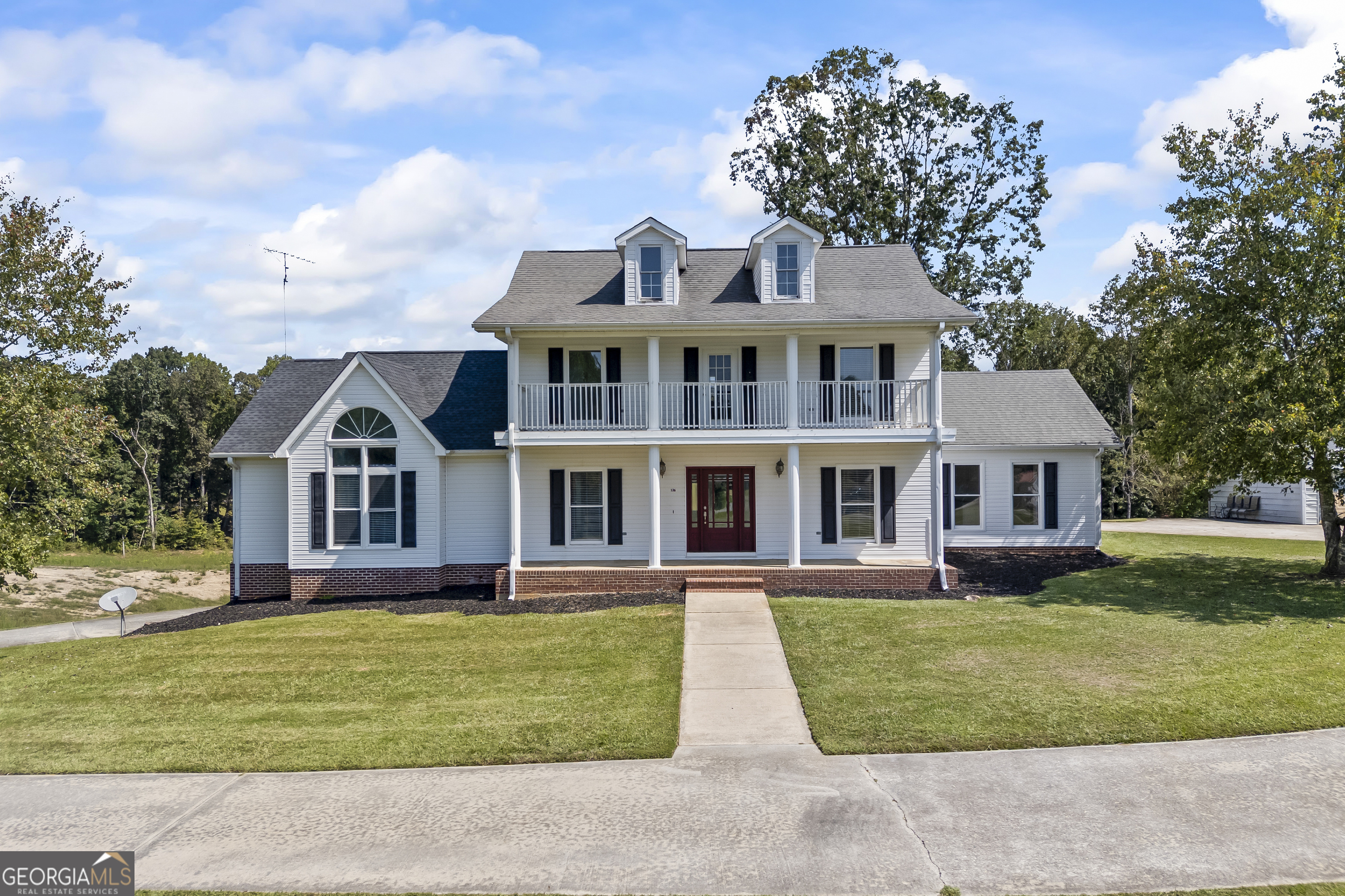 Situated on a hill on 9.57 acres, this colonial-style home is sure to impress! The large kitchen with quartzite countertops features beautiful blue and white cabinets, a gorgeous tile backsplash, and high end stainless steel appliances including refrigerator! Your new living room features a brick fireplace with gas logs and the seller is leaving a very nice entertainment center. The large primary suite features a sitting room/office with a built in bookcase! The primary bathroom has tile flooring and dual vanities/closets! You will love the massive laundry! Built-ins, a huge island, and a 1/4 bath. Upstairs you will find 3 bedrooms and a full bath as well as an amazing view off of the balcony! In the basement you will find a full apartment with kitchen, laundry room, living room, bedroom, full bathroom, and several flex rooms for use in many different ways! This home has fresh paint, 3 HVAC systems that are all less than 3 years old, and has been taken care of by its owners!