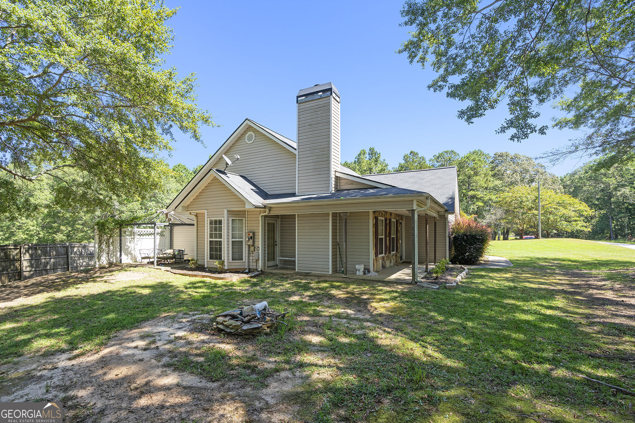 Charming 3 Bedroom, 2 Bath Ranch on 4.78 Acres - Country Living at Its Finest! Welcome to your dream home nestled in the desirable Walnut Grove High School District! Enjoy 3 generous bedrooms and 2 beautifully appointed bathrooms. The master bath boasts an updated tile shower, double vanities, and a large walk-in closet for all your storage needs. The heart of the home is a large kitchen equipped with painted cabinets, a stylish tiled backsplash, and a butcher block island/breakfast bar, perfect for family gatherings and entertaining. Step outside to your expansive 4.78 acres, with over 3 acres cleared and grassed. The backyard and side yard are fully fenced, providing a safe haven for children and pets. Dive into the above-ground pool on hot summer days or enjoy the bounty of your own fruit garden, featuring raspberry, blueberry, elderberry bushes, and a variety of fruit trees including fig, peach, plum, pear, and apple. The property includes a chicken coop for fresh eggs, two outbuildings for extra storage, and an enclosed garage that has been converted into an office space and separate storage area. The home features LVP flooring throughout, with tiled bathrooms for a modern touch. A separate dining room with a cozy sitting area adds to the charm and functionality of this lovely home. This property is perfect for those seeking a peaceful retreat with plenty of space for outdoor activities and gardening. Don't miss the opportunity to own this slice of paradise! Schedule your showing today!